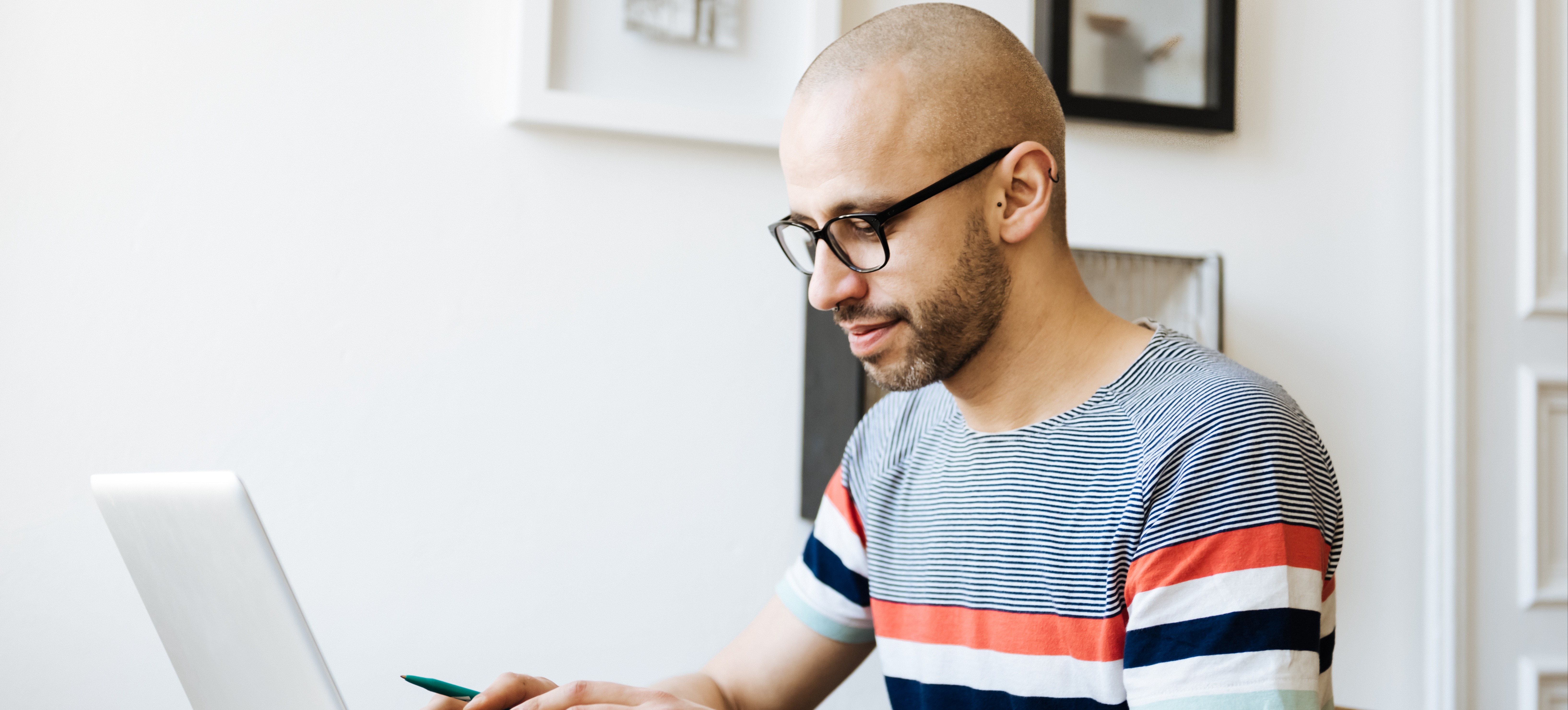 [Featured Image] Person works on their laptop as they earn a Cisco certification online. 
