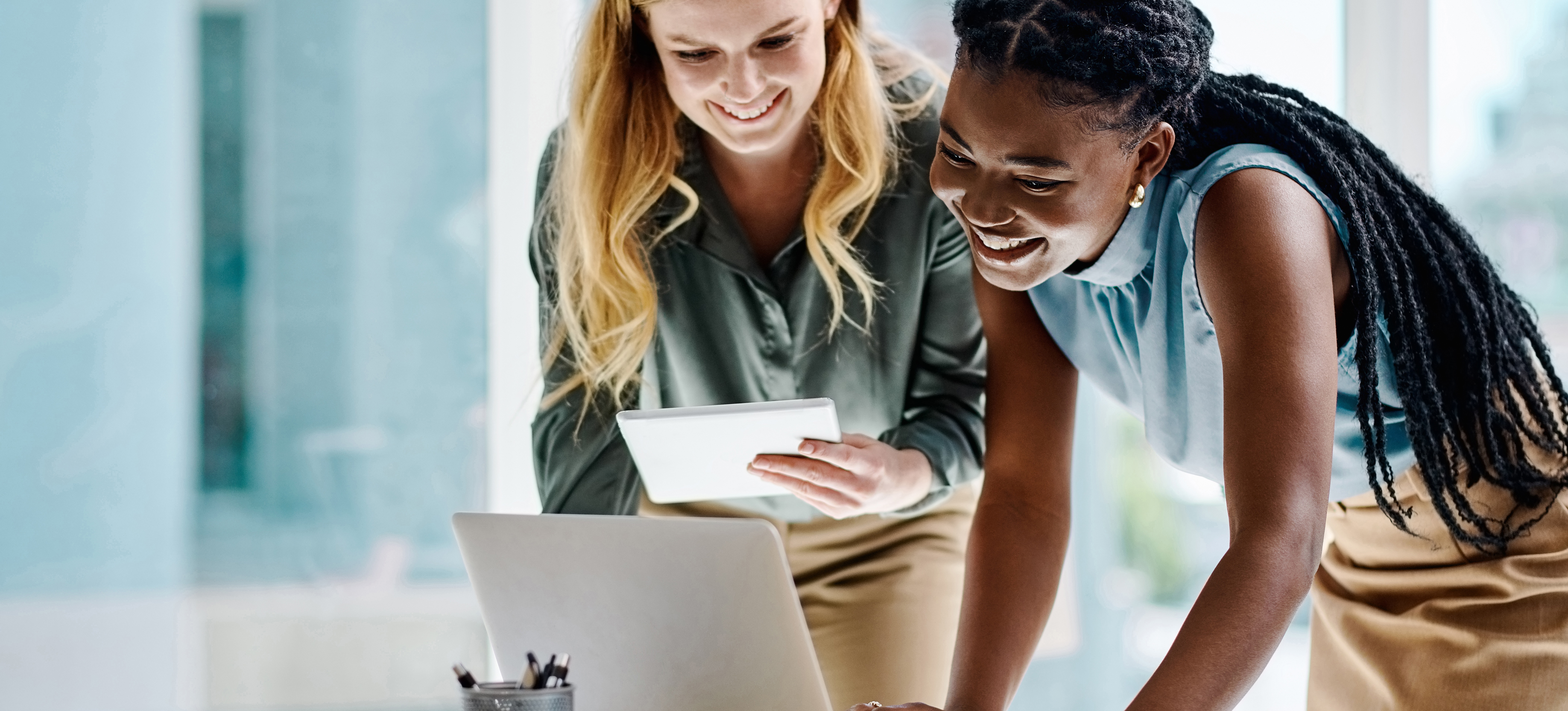 [Featured Image]: Two human resources employees use artificial intelligence to evaluate potential job candidates.
