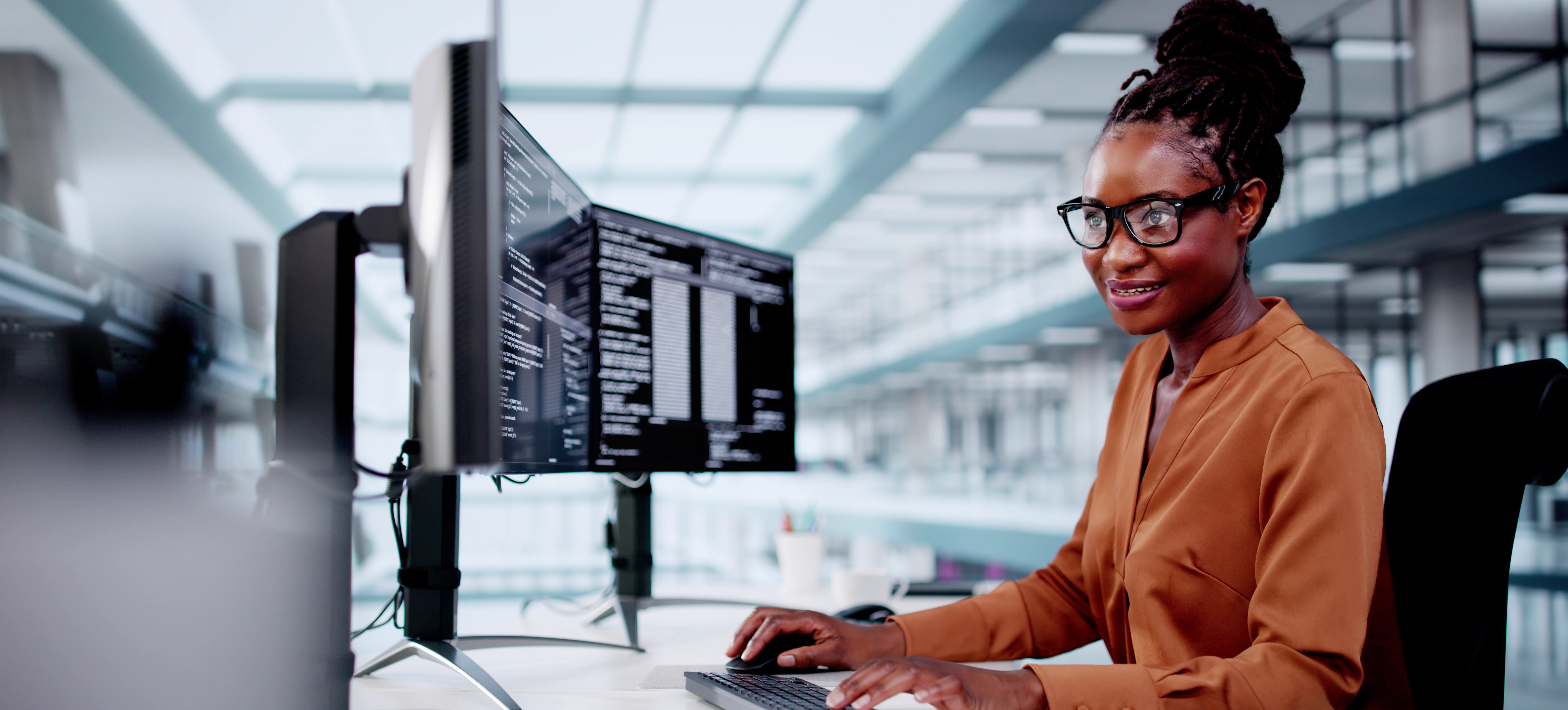 [Featured Image] A computer programmer types code to guide the AI in generating content.
