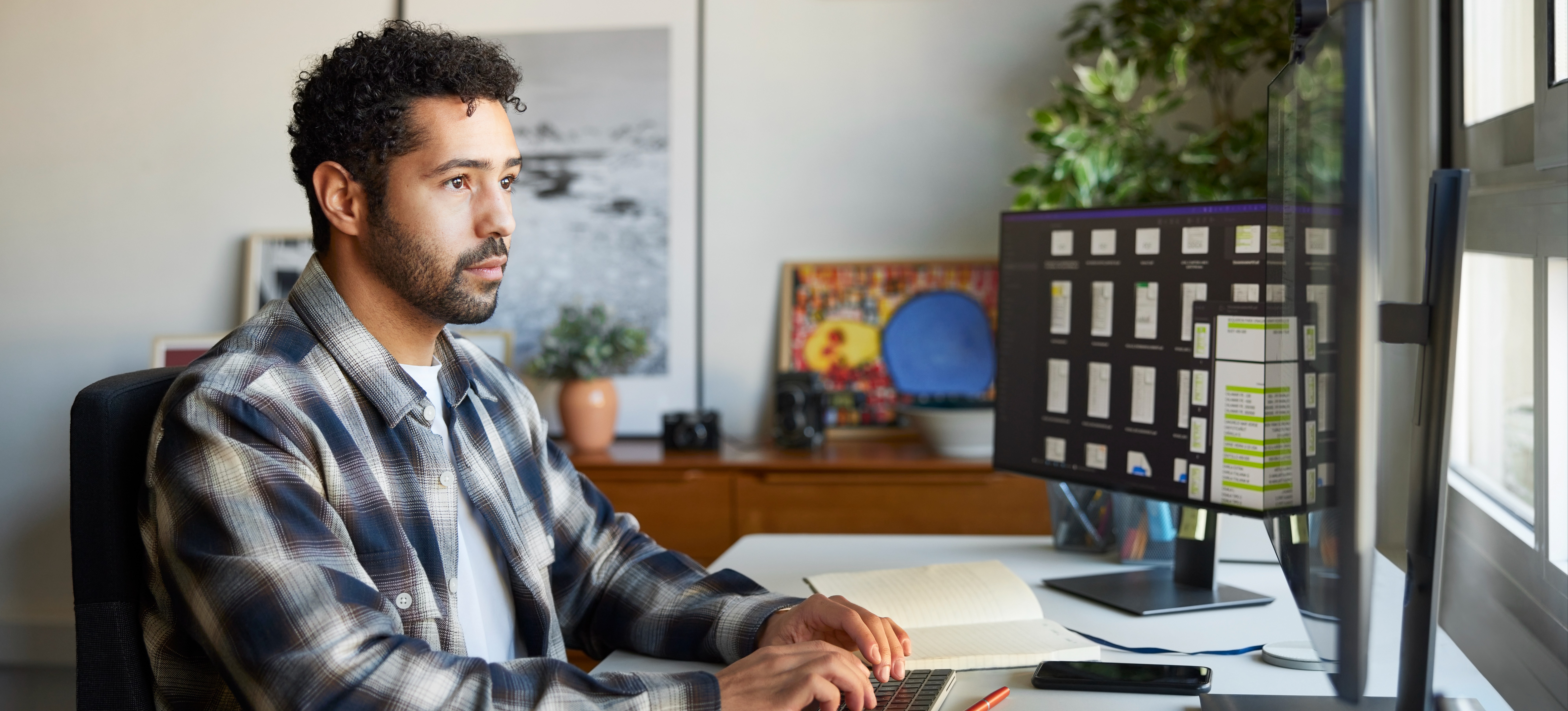 [Featured Image] A person who earns a cloud developer salary sits at their home office desk working at a computer.
