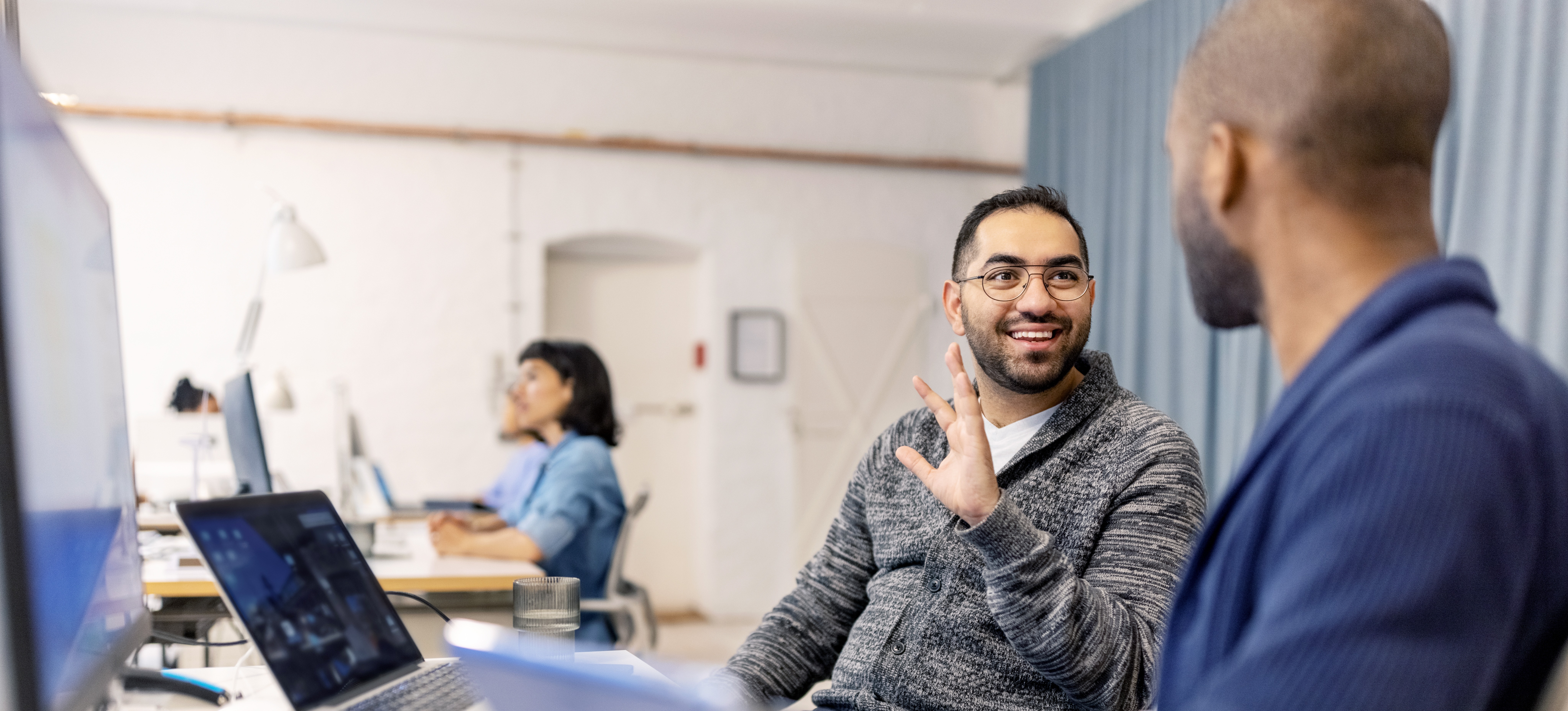 [Featured Image] Two software developers discuss the progress of their field due to AutoGen.
