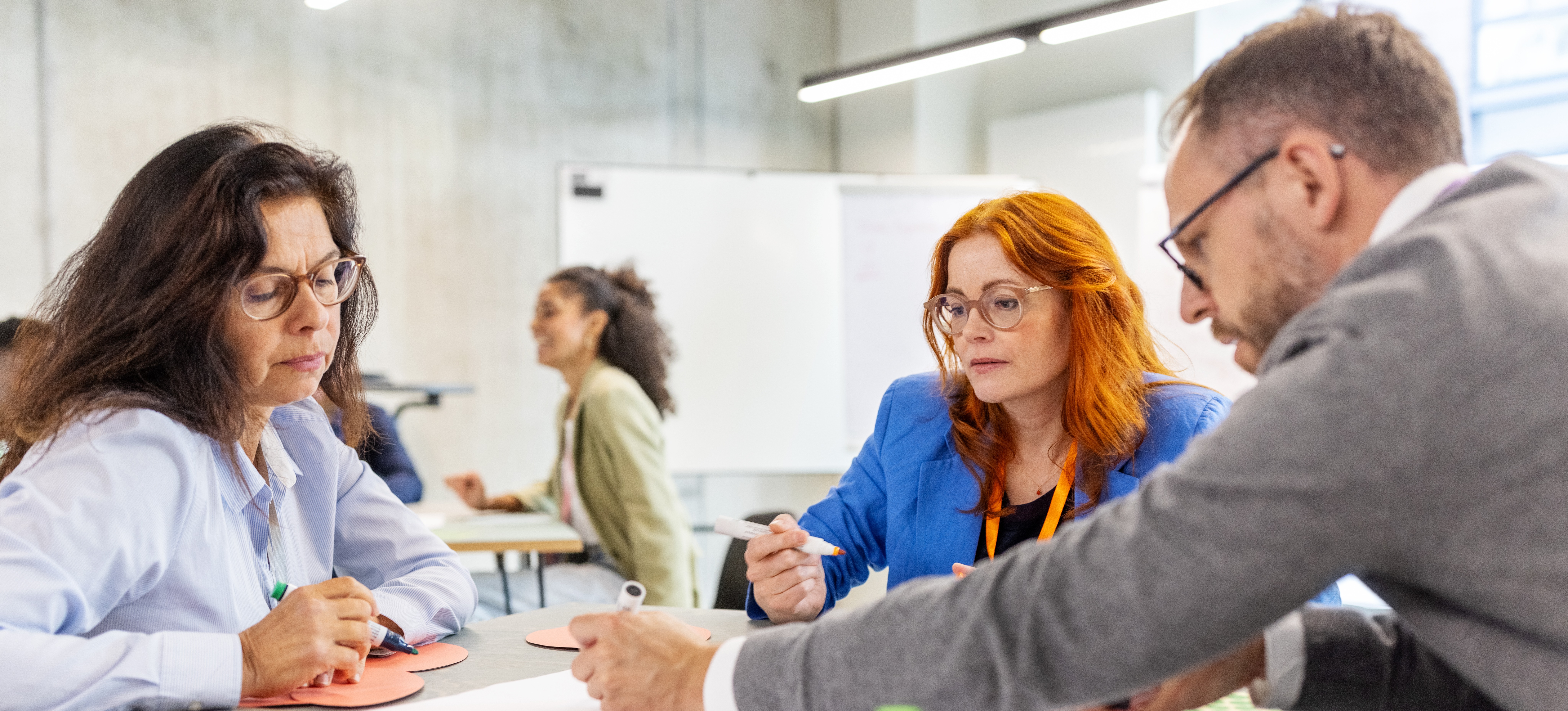 [Featured Image]: Three colleagues model choices to understand what game theory reveals about cooperation and competition.
