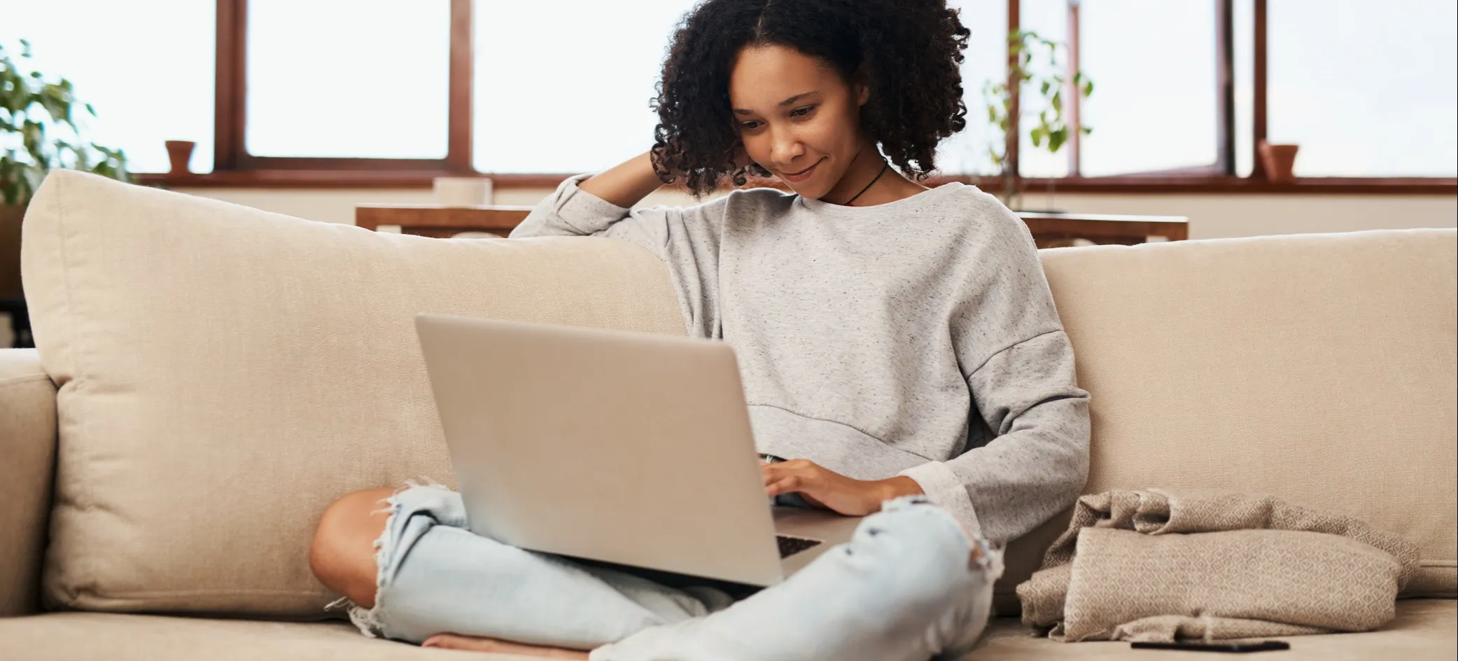 [Featured image] A person looks up the CCNA certification at home on their laptop.