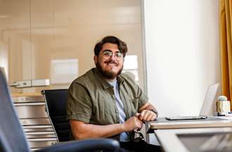 [Featured image] A software engineer is sitting at a desk with a laptop in front of them. 