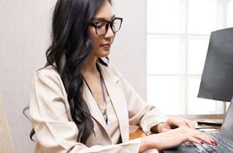 [Featured Image] A DevOps engineer practices her DevOps skills in her office.