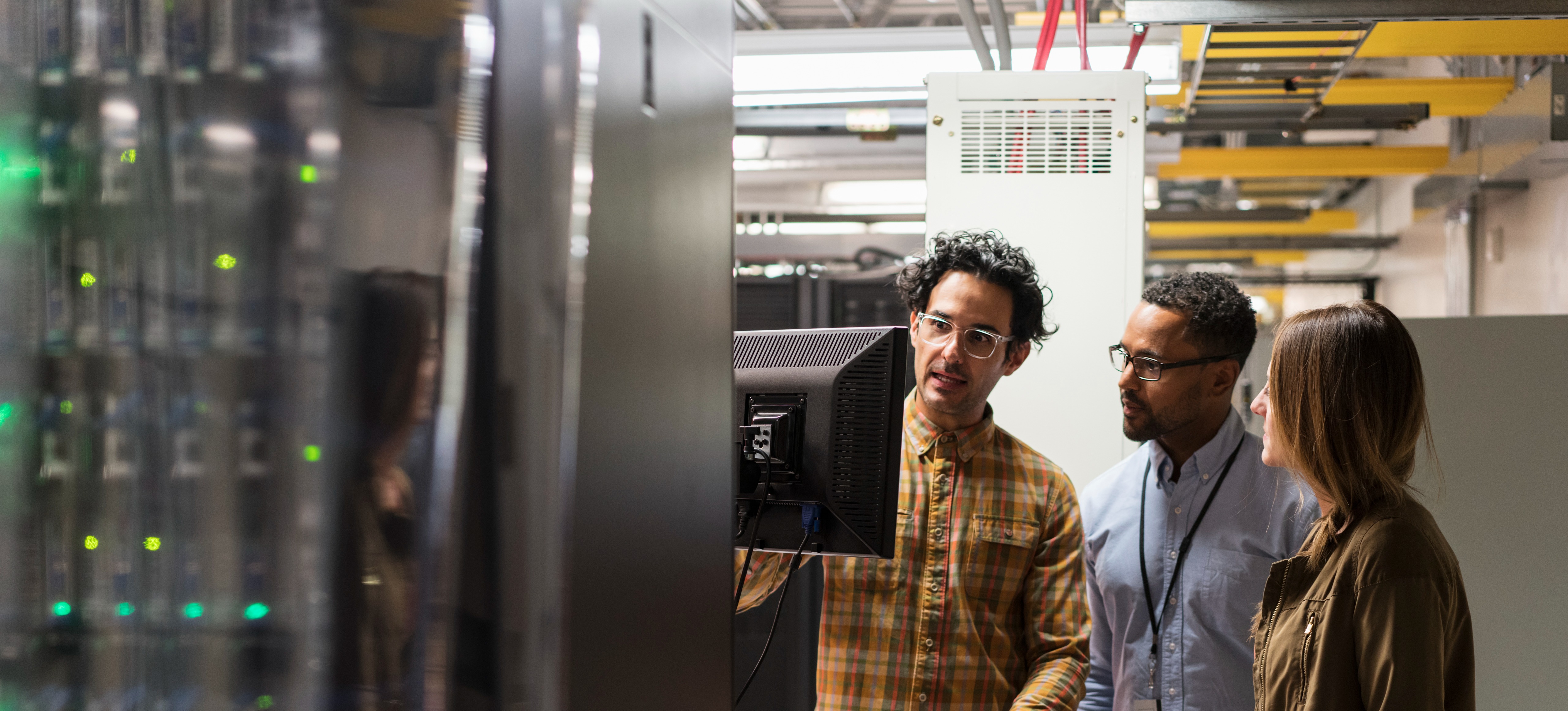[Featured Image]:  Team members working together discuss the best ways to improve the latest project. 