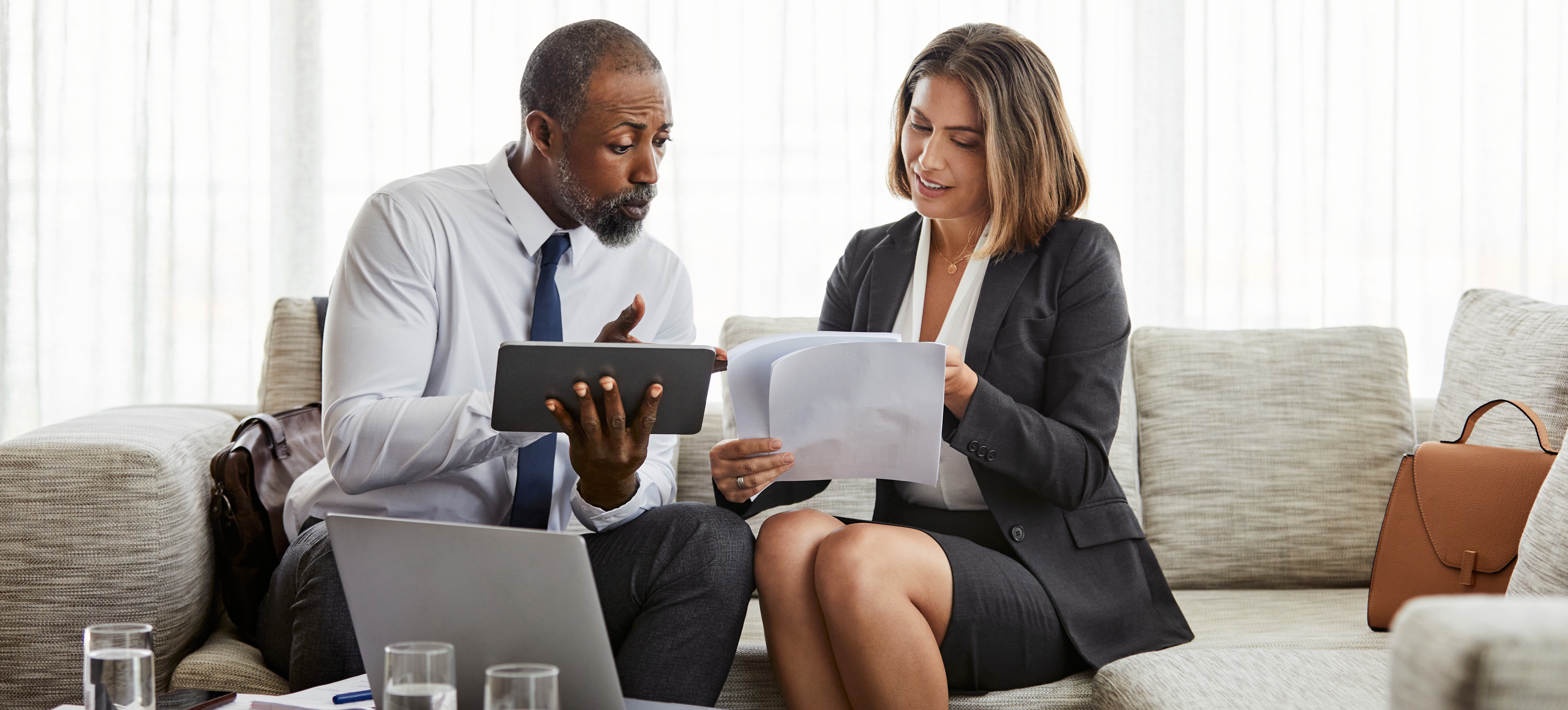 [Feature Image] A business systems analyst reviews recommendations with a business leader as they discuss ongoing strategies for process improvements.
