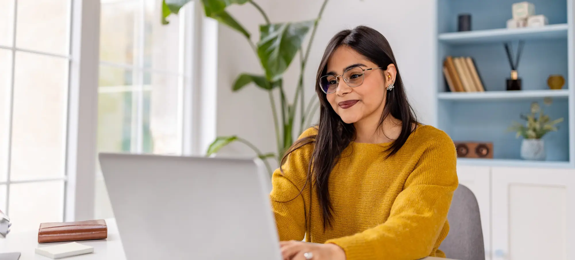 [Featured Image] An SEO specialist works on a laptop computer at a desk.