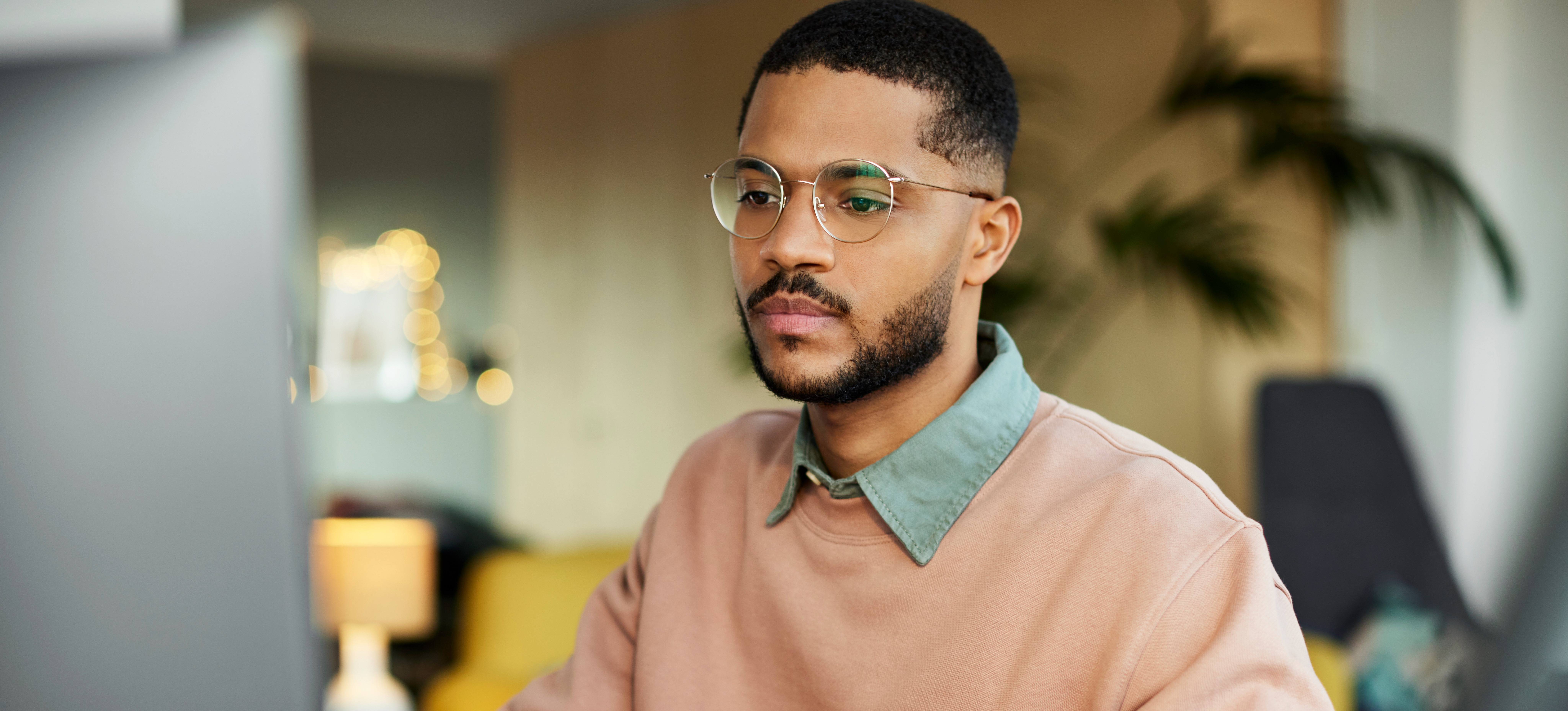 [Featured Image] Male college students uses computer to learn the benefits of having a CGEIT