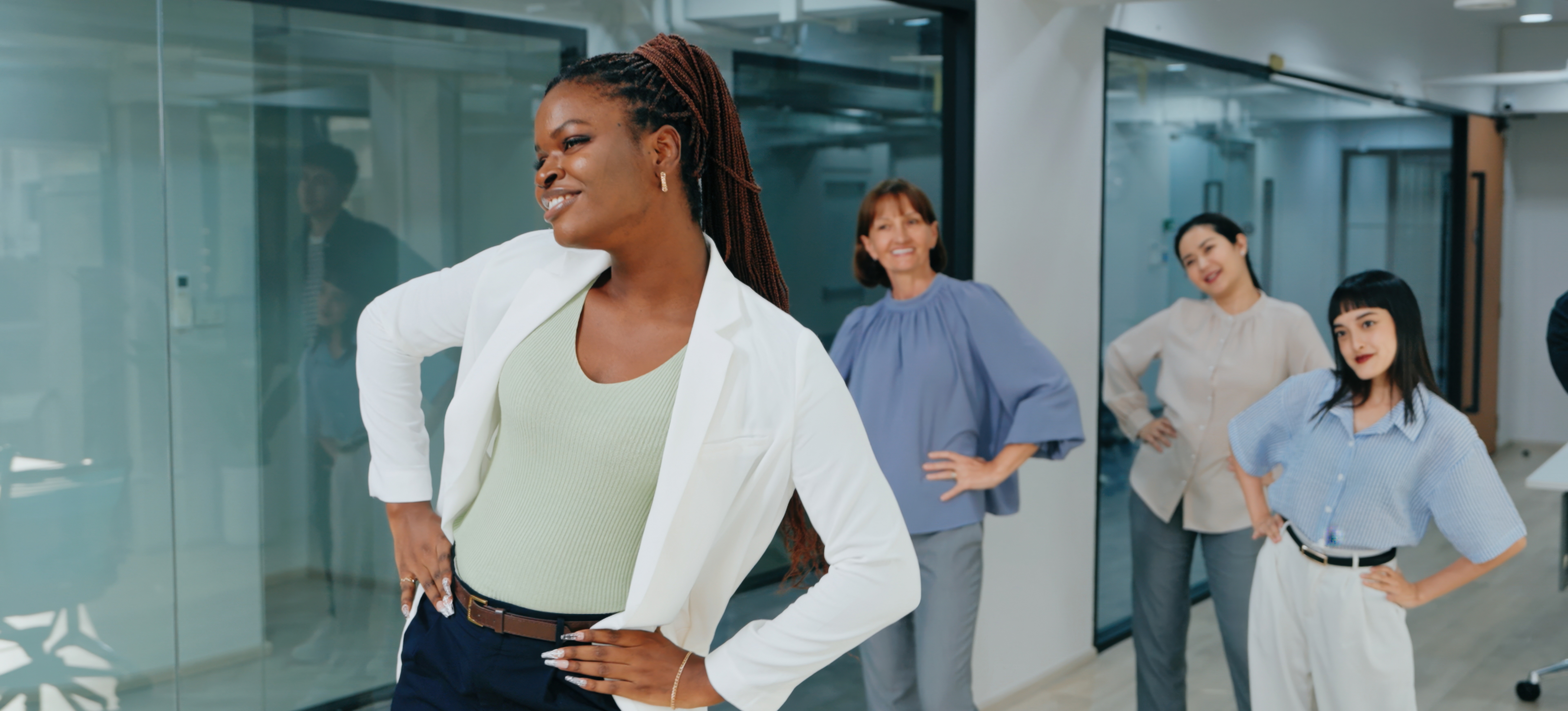 [Featured Image] A group of professionals in a workplace environment engaging in stretching exercises, promoting psychological safety and well-being in the office.