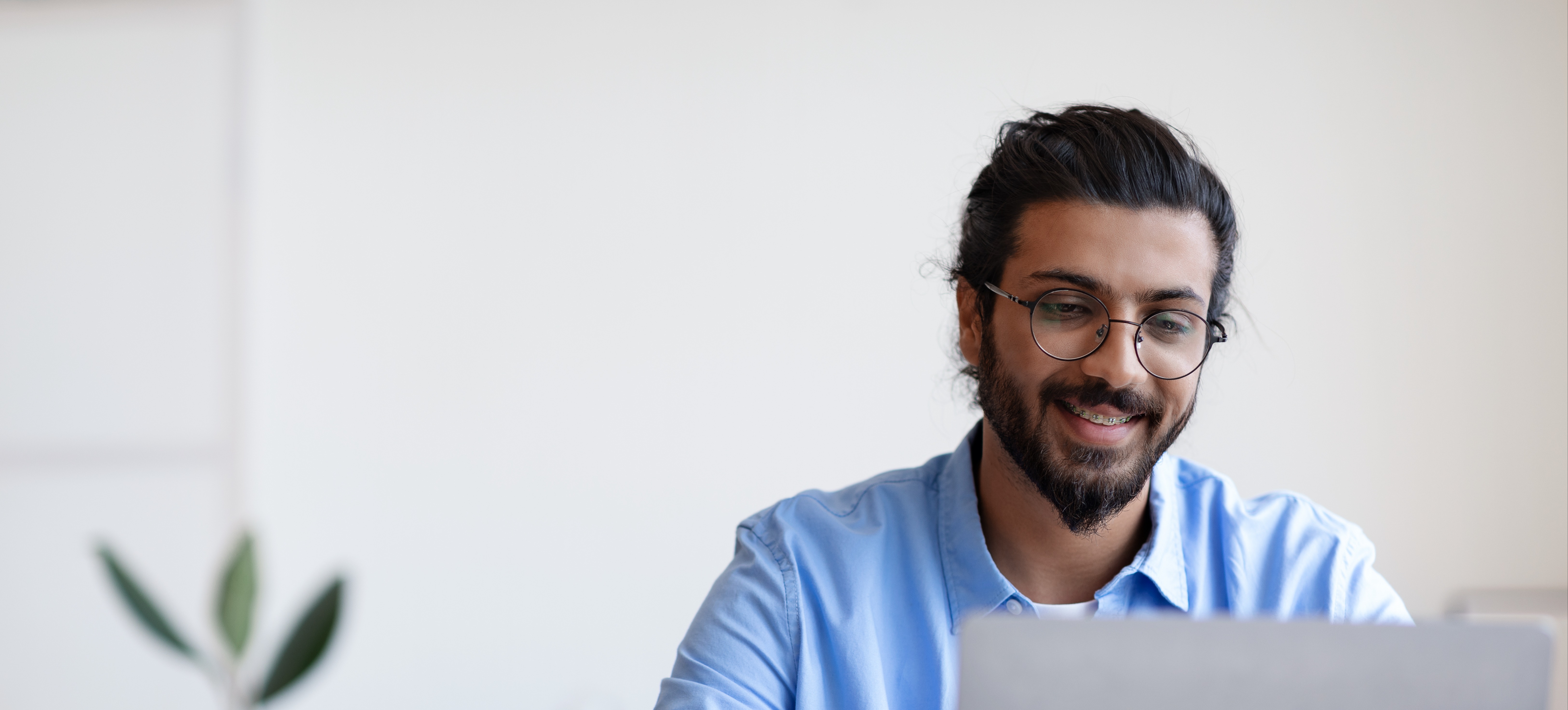 [Featured Image]:  A person in a medical sales job is sitting at his desk, working on their laptop computer, as they make contact with a potential client. 
