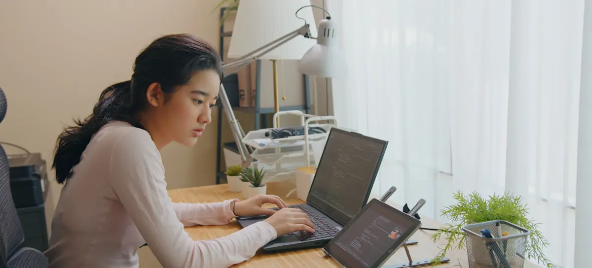 [Featured Image]:  A data analyst is learning the basics of SQL and MySQL at their computer in a home office.