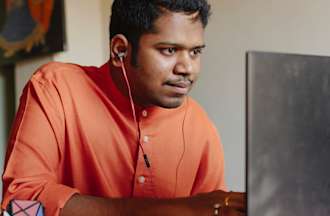 [Featured Image] A data engineer works on maintaining a data warehouse while working on his computer.