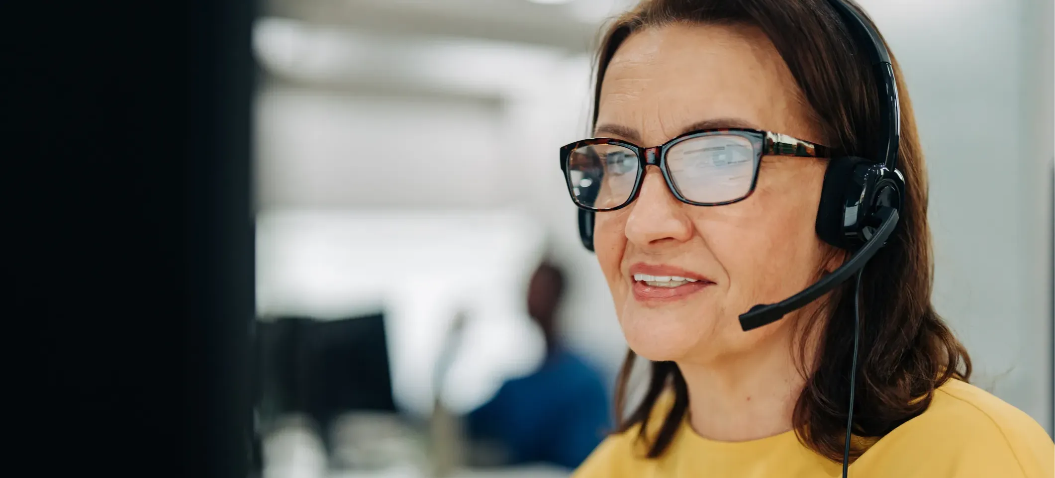 [Featured Image] A customer service professional leverages service quality management strategies to provide a positive customer experience over the phone. 
