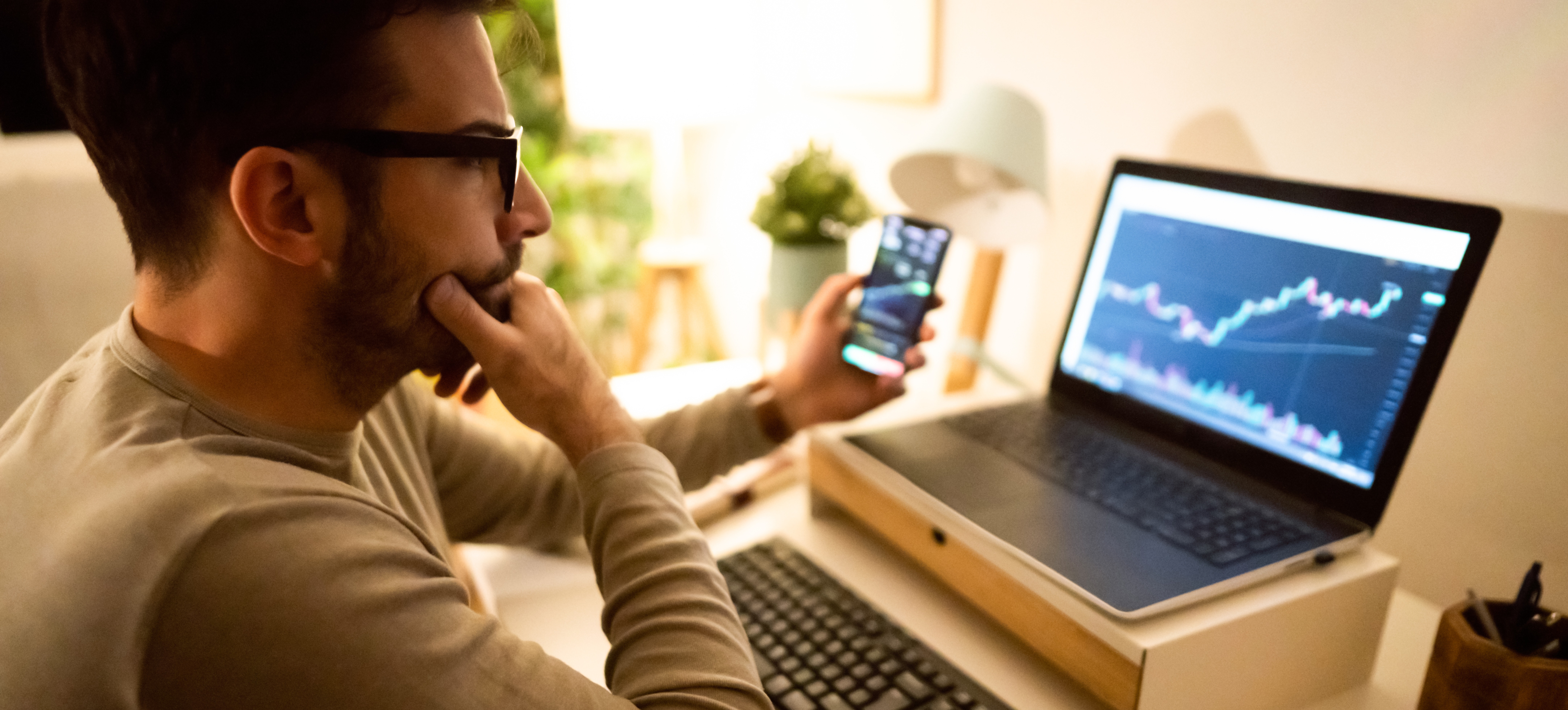 [Featured Image] A person seated at their laptop is pondering the data visualization graphs formed by statistical analysis software.
