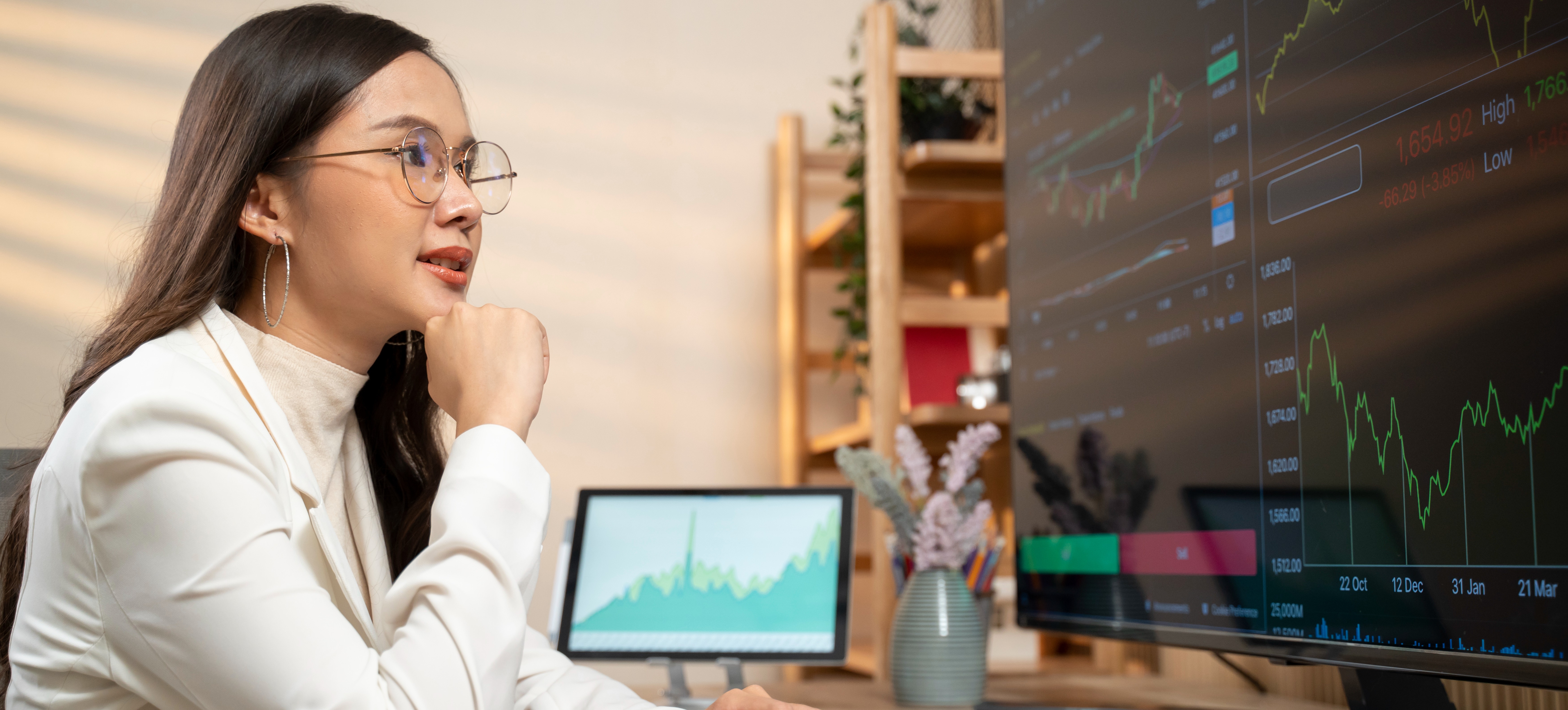 [Featured Image] A person sits at a desk and uses analytical skills while viewing financial data on a computer. 