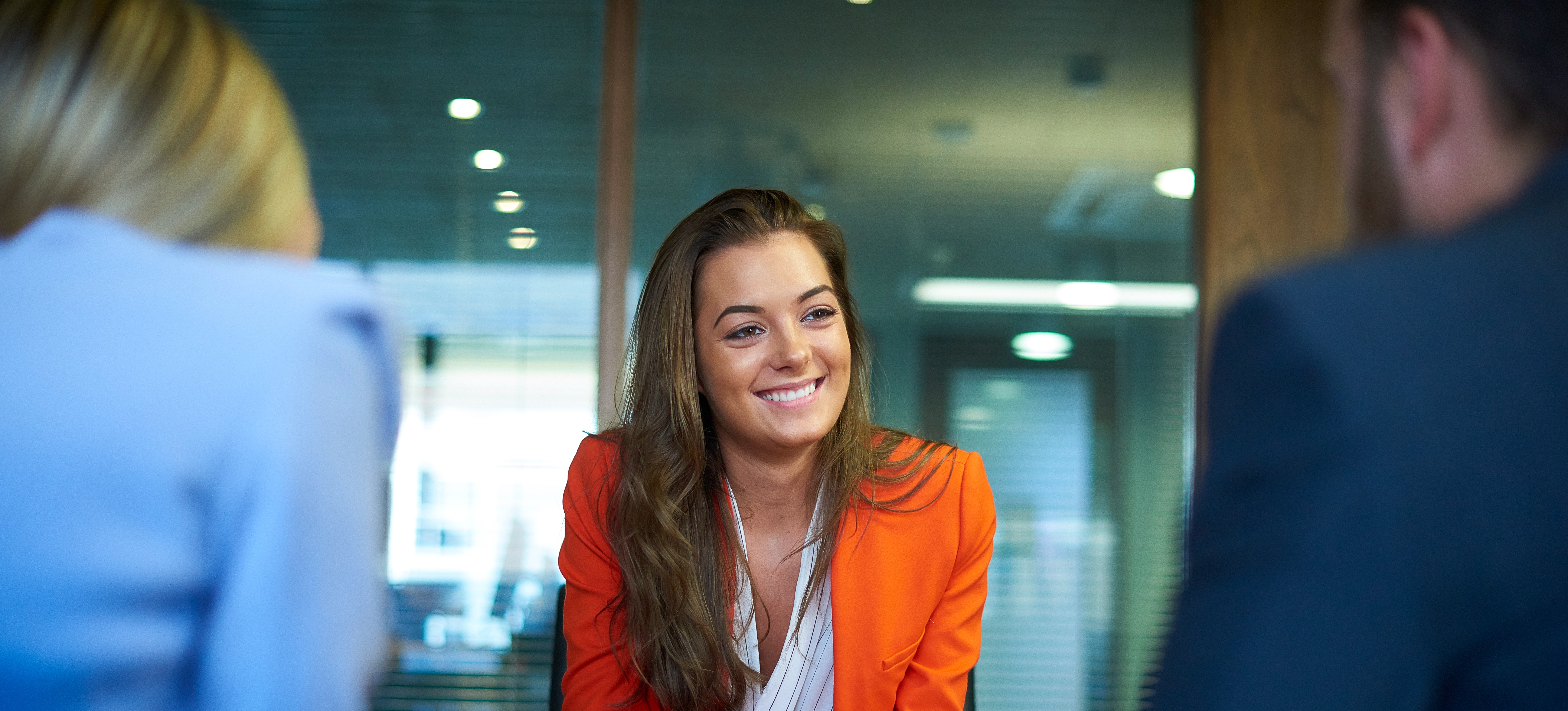 [Featured image] A sales representative is discussing about a new product with their team. 
