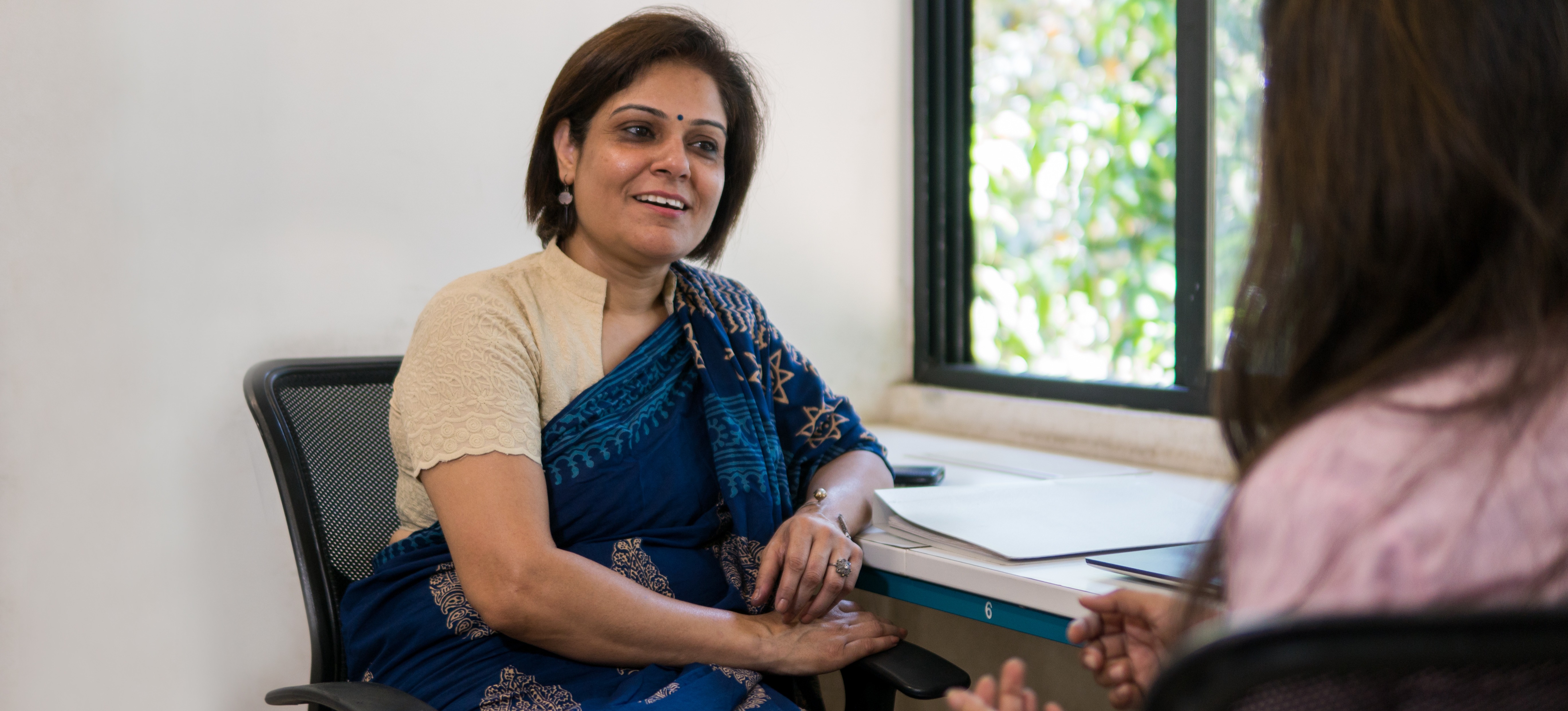 [Featured Image] An HR manager asks data analyst interview questions to a potential hire.