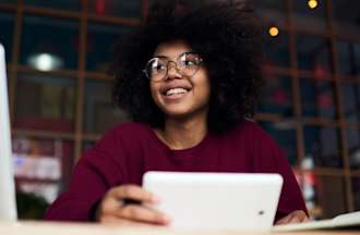 [Featured Image] A marketer works on a laptop in the office.