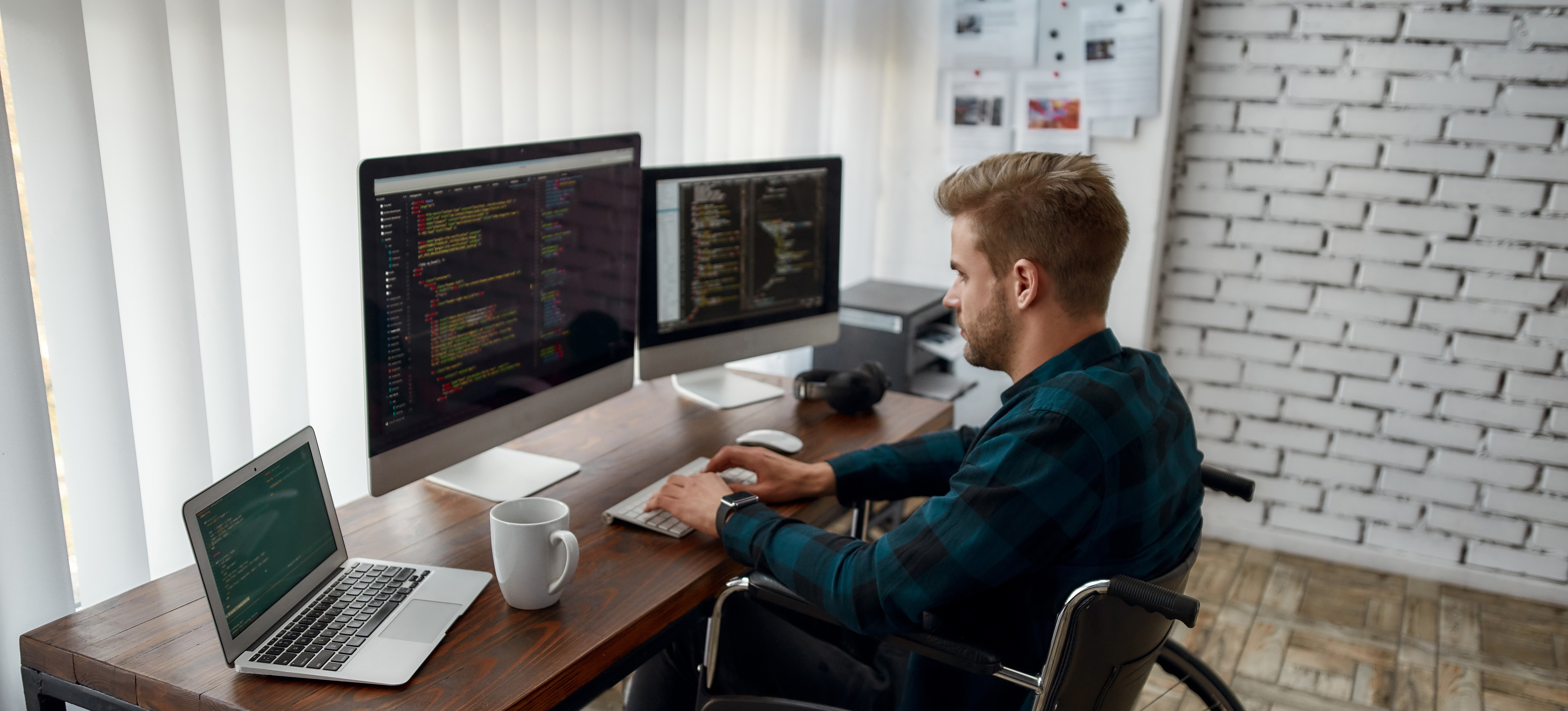 [Featured Image] A blockchain developer works on code in front of several monitors.
