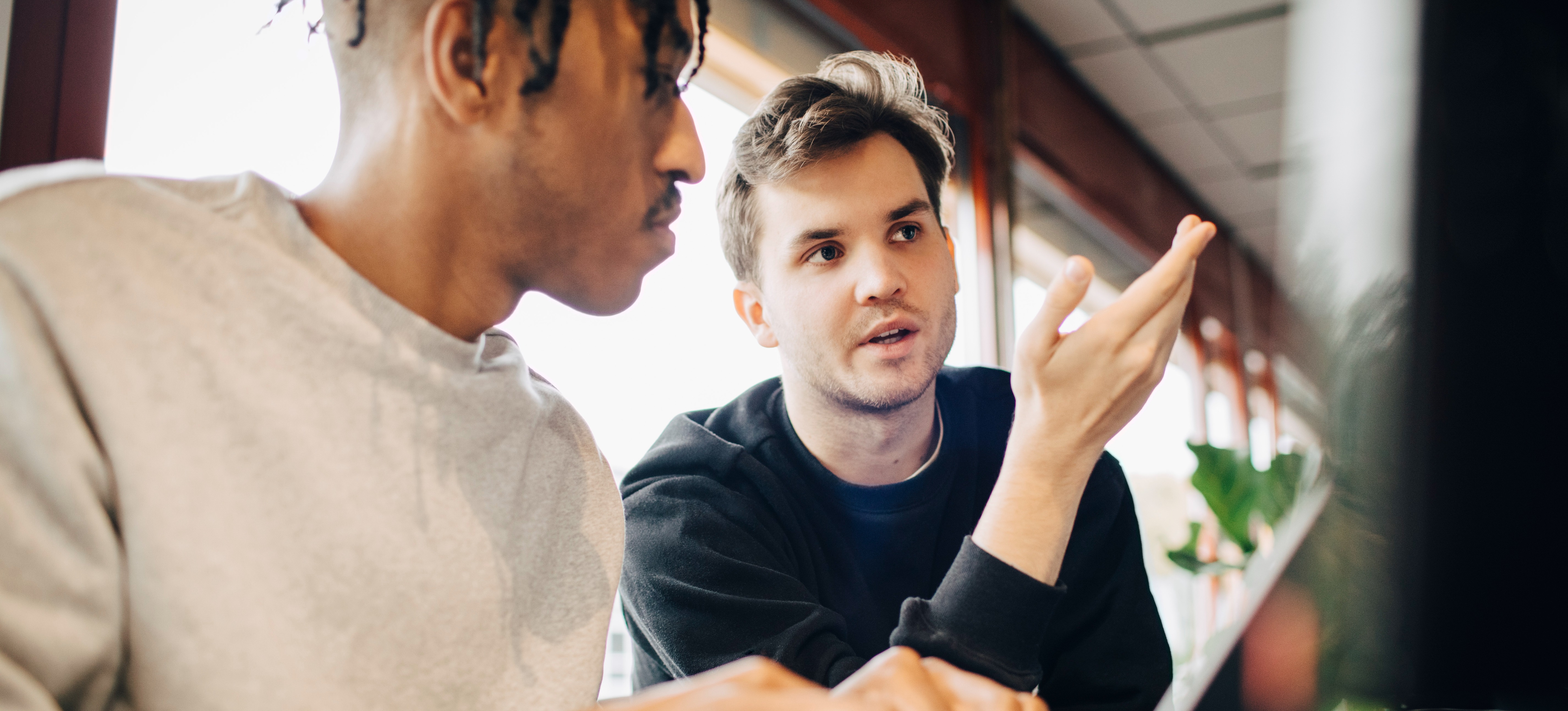 [Feature Image] Two learners discuss the topic, “What is a Markov decision process,” as they plan how to use it to aid in a project.
