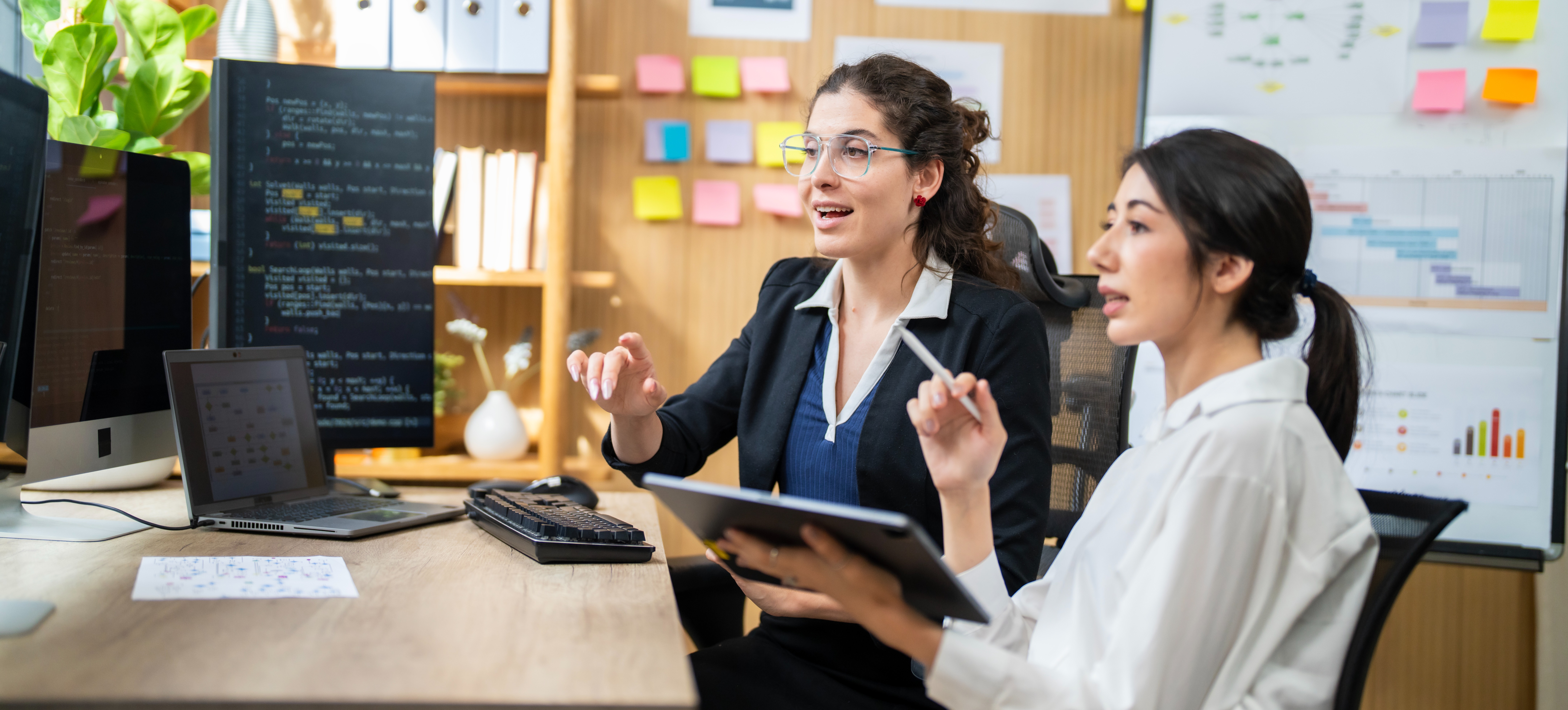 [Featured Image] Java specialists in a workspace, interacting while reviewing Java code on a computer and discussing the topic.
