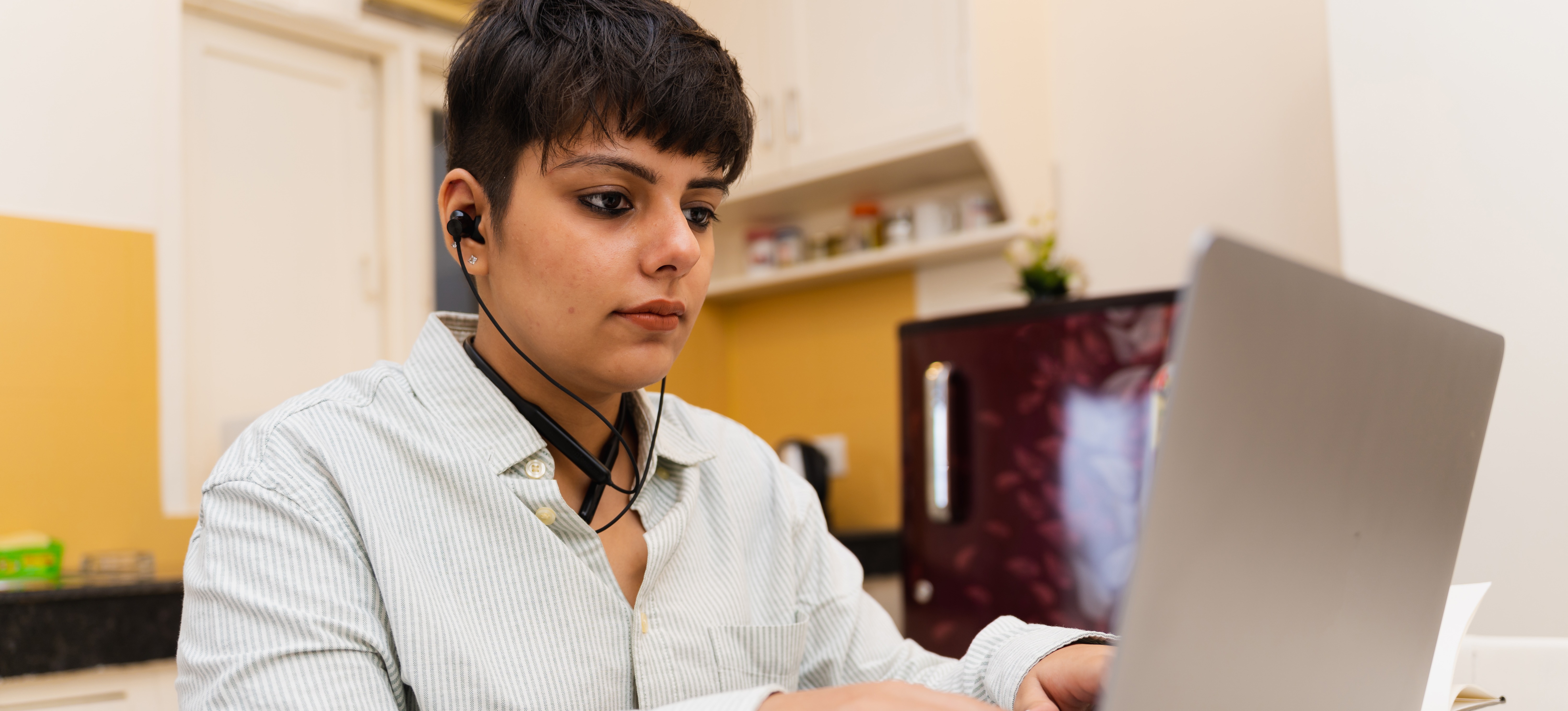 [Featured Image] A young learner researches an overview of Cisco certifications whilst choosing a training path. 
