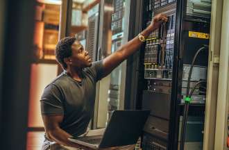 [Featured image] A security engineer is doing maintenance on his company's physical server machines.