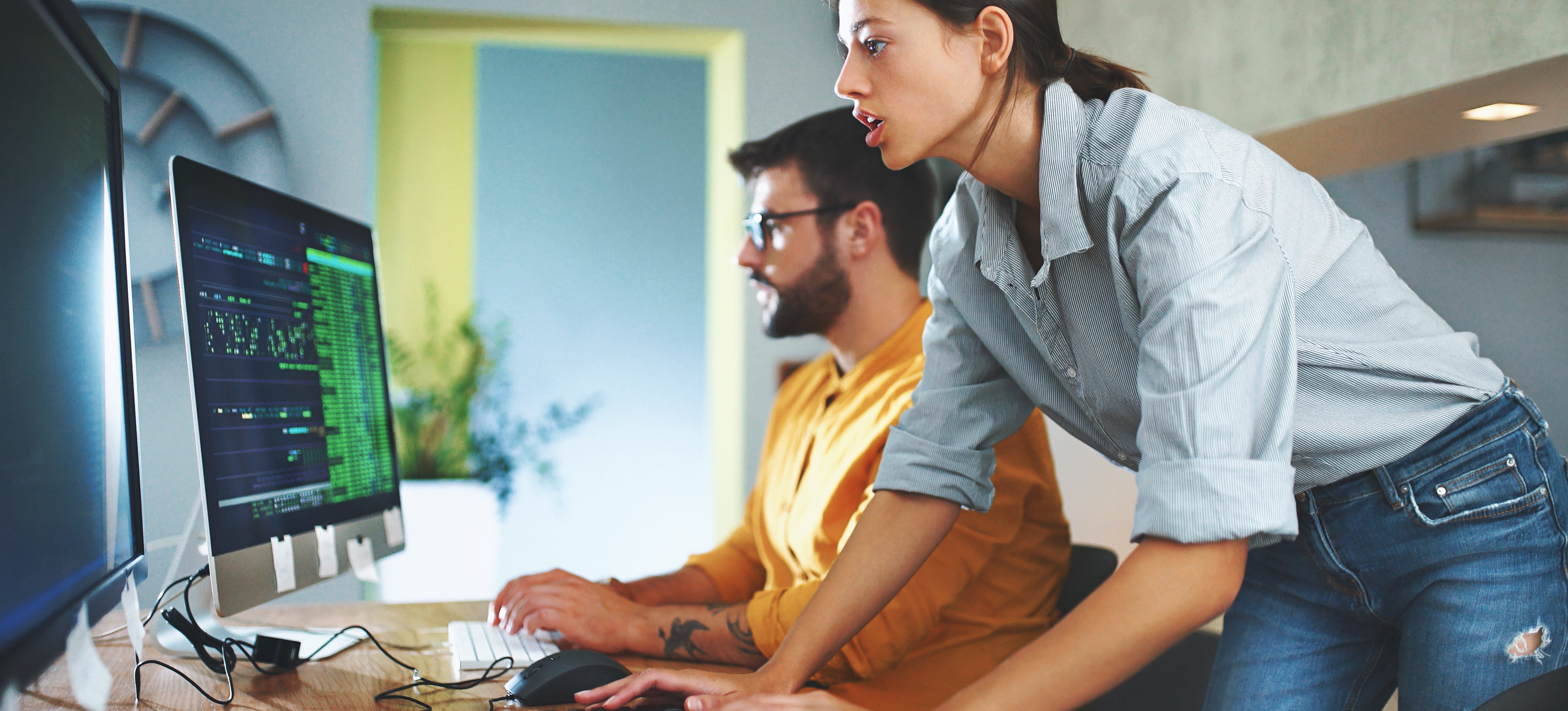 [Featured Image] Power BI specialists in a professional workspace, examining Power BI on their computers.
