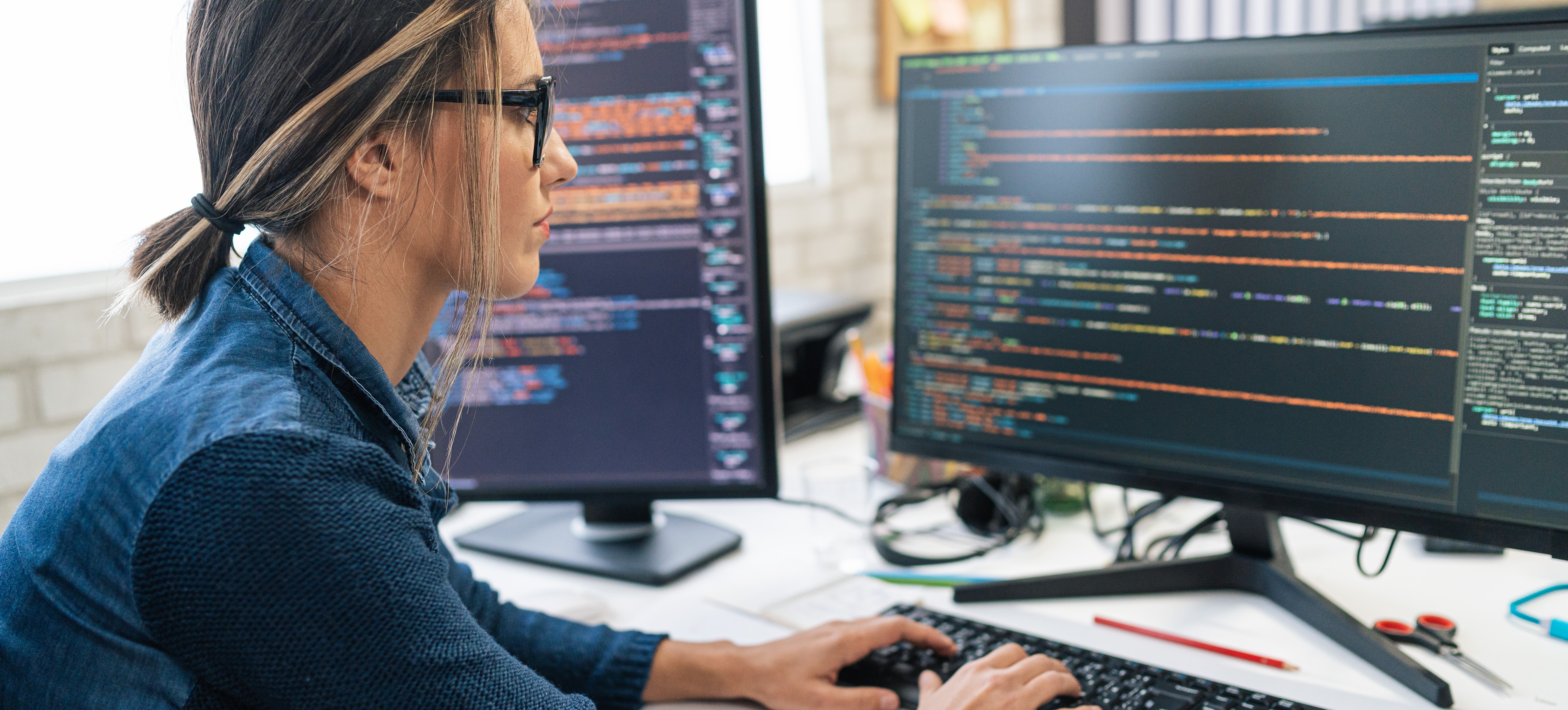 [Featured Image] A software engineer learns new programming languages to advance their career.
