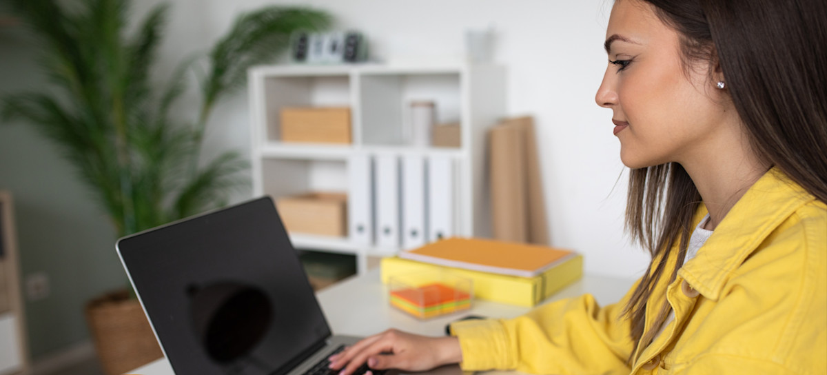 [Featured Image] A person is on their laptop editing their shopify "shipping from" address.