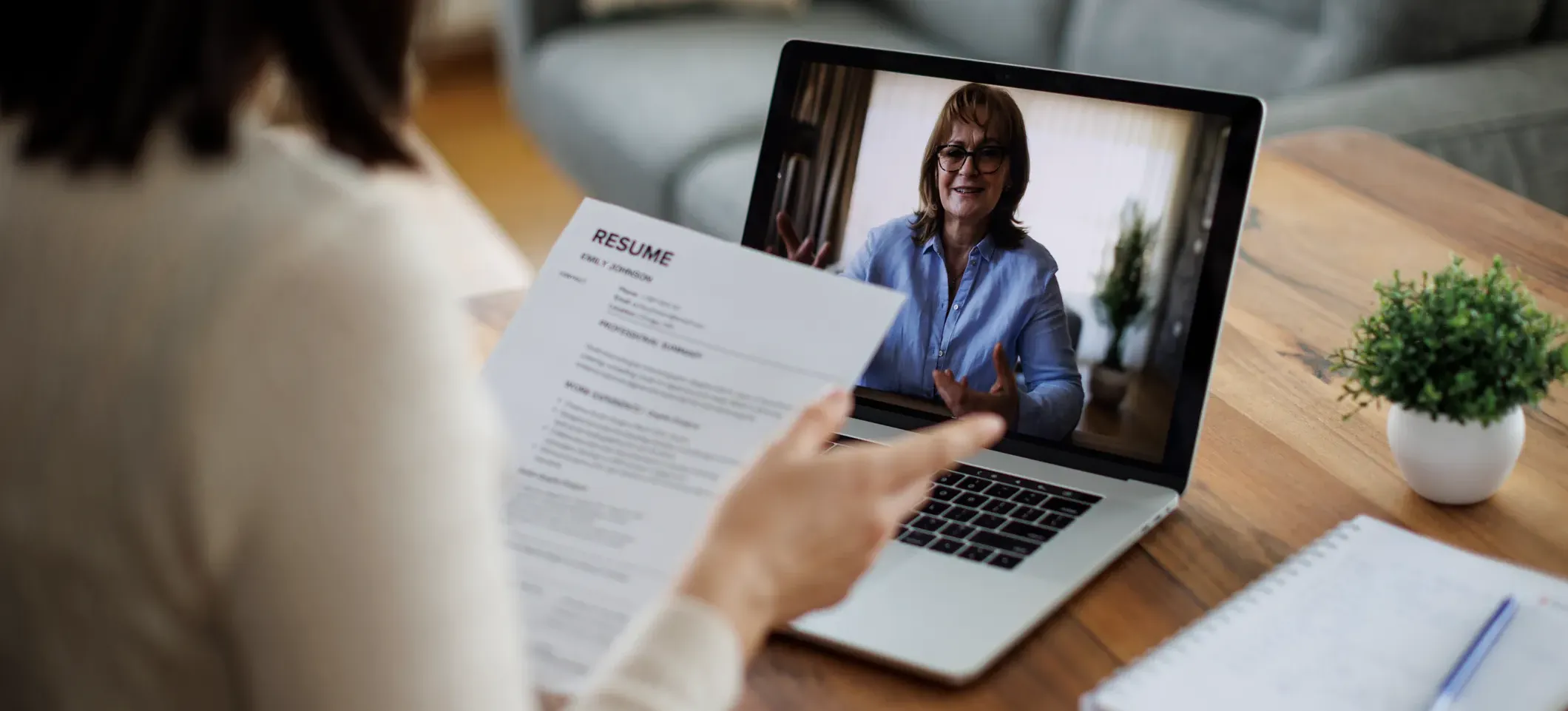 [Featured Image]: A recruiter uses a laptop to interview a candidate who successfully used ChatGPT for their job search.
