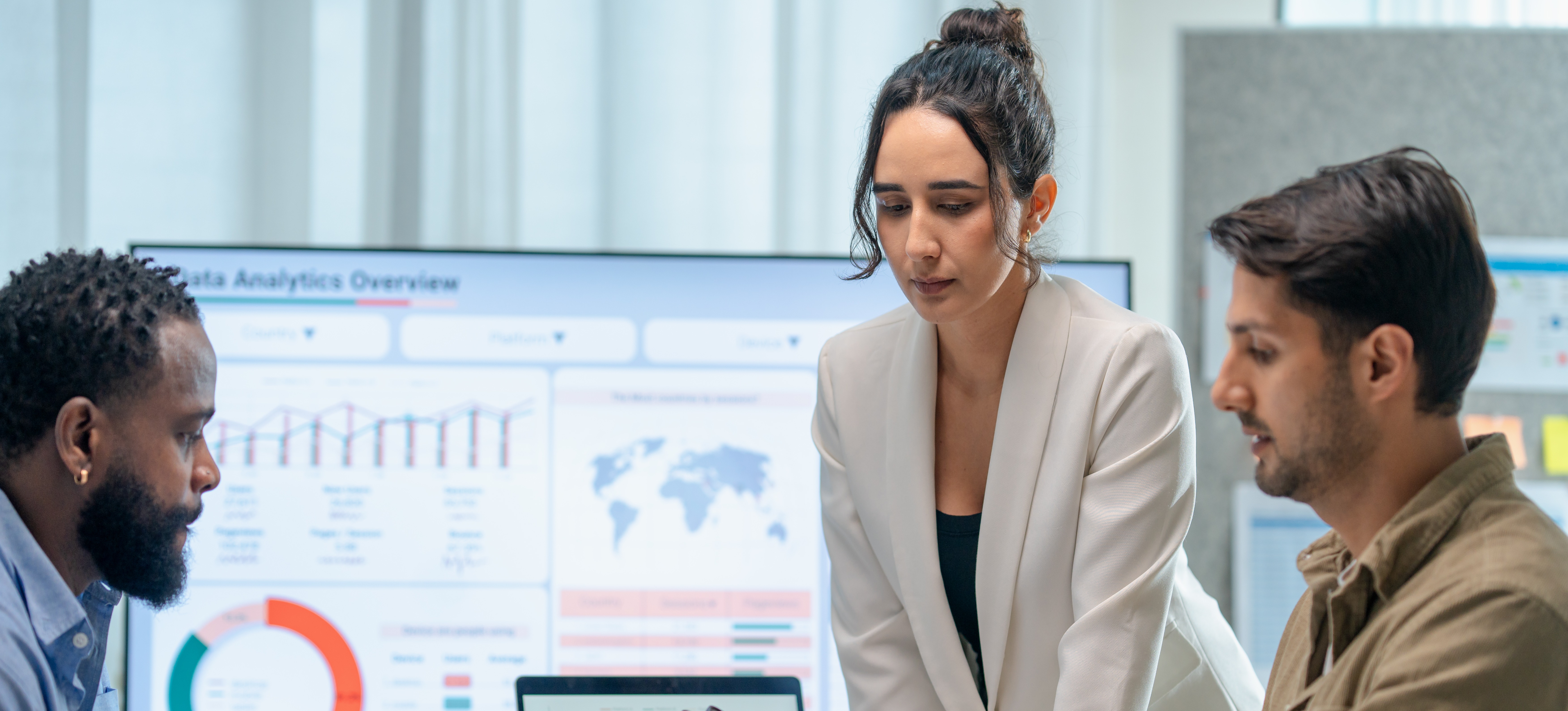 [Featured Image] A business team meets in a conference room to discuss how to use Python libraries for data analysis.
