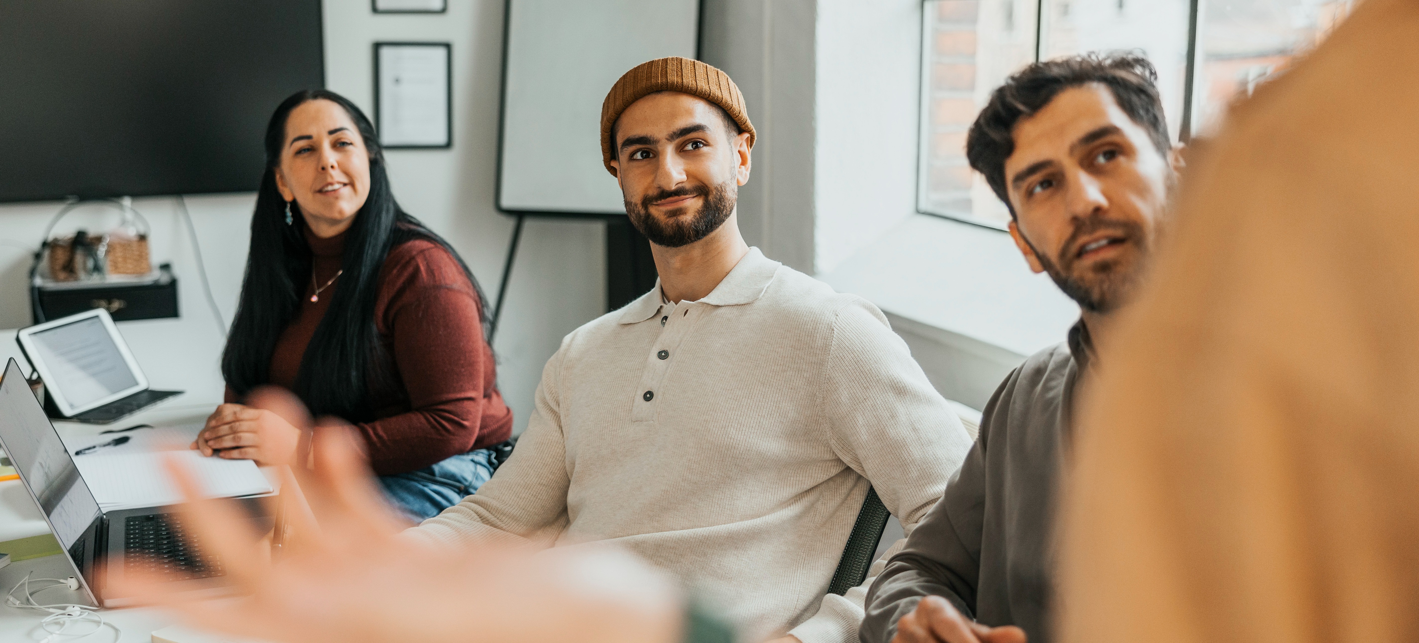 [Featured Image] A group of learners gather in a classroom setting to learn more about the various types of AI agents and how to build their own. 
