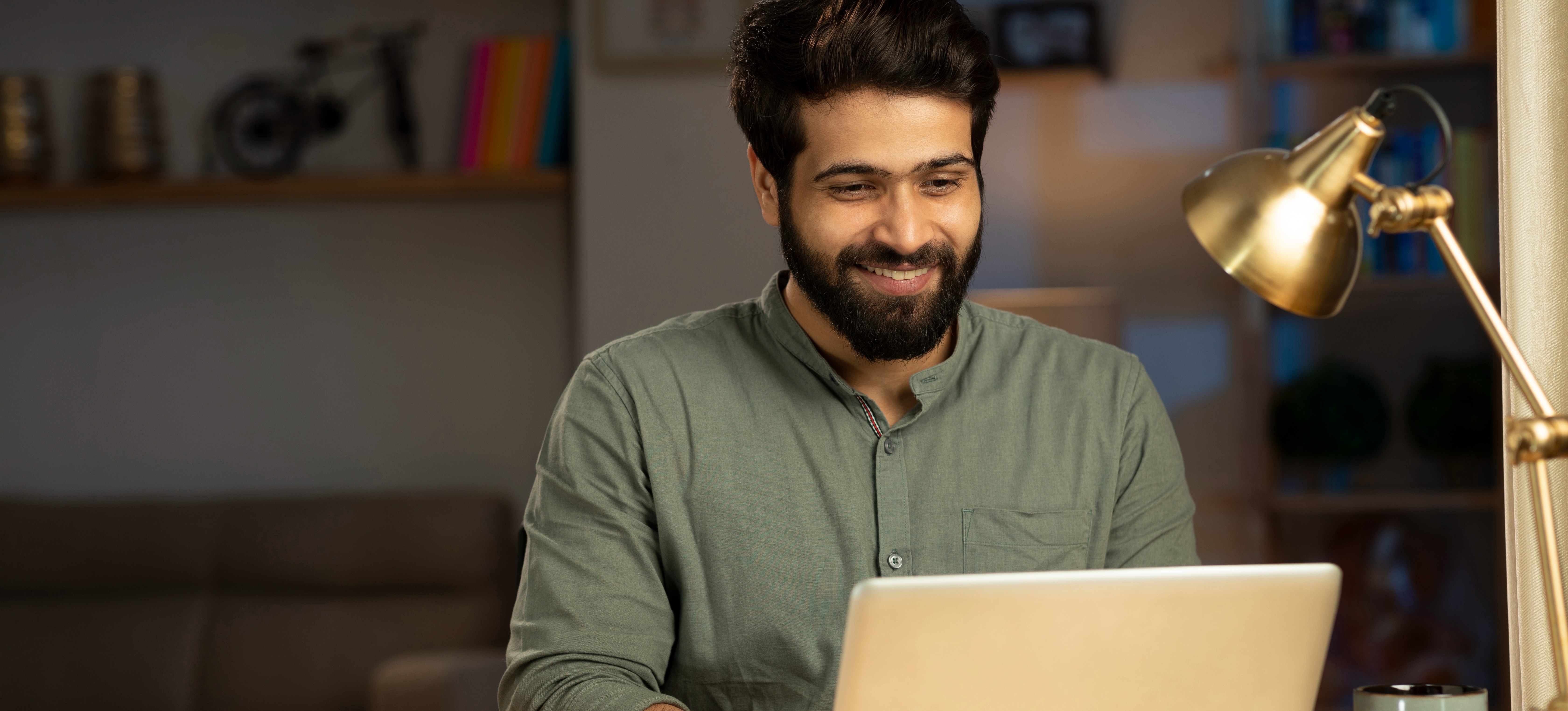 [Featured Image]: A learner smiles after following the steps to add their resume to LinkedIn to support their job search.
