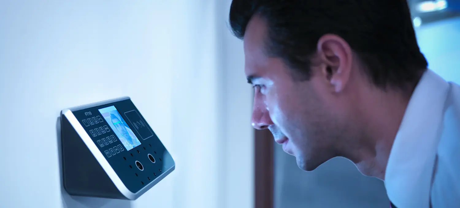 [Featured image] A person uses facial recognition biometrics to gain access to an office building.
