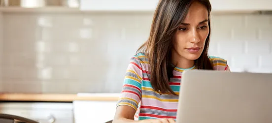 [Featured Image] A person who recently earned certifications works on creating a CompTIA A+ resume. 
