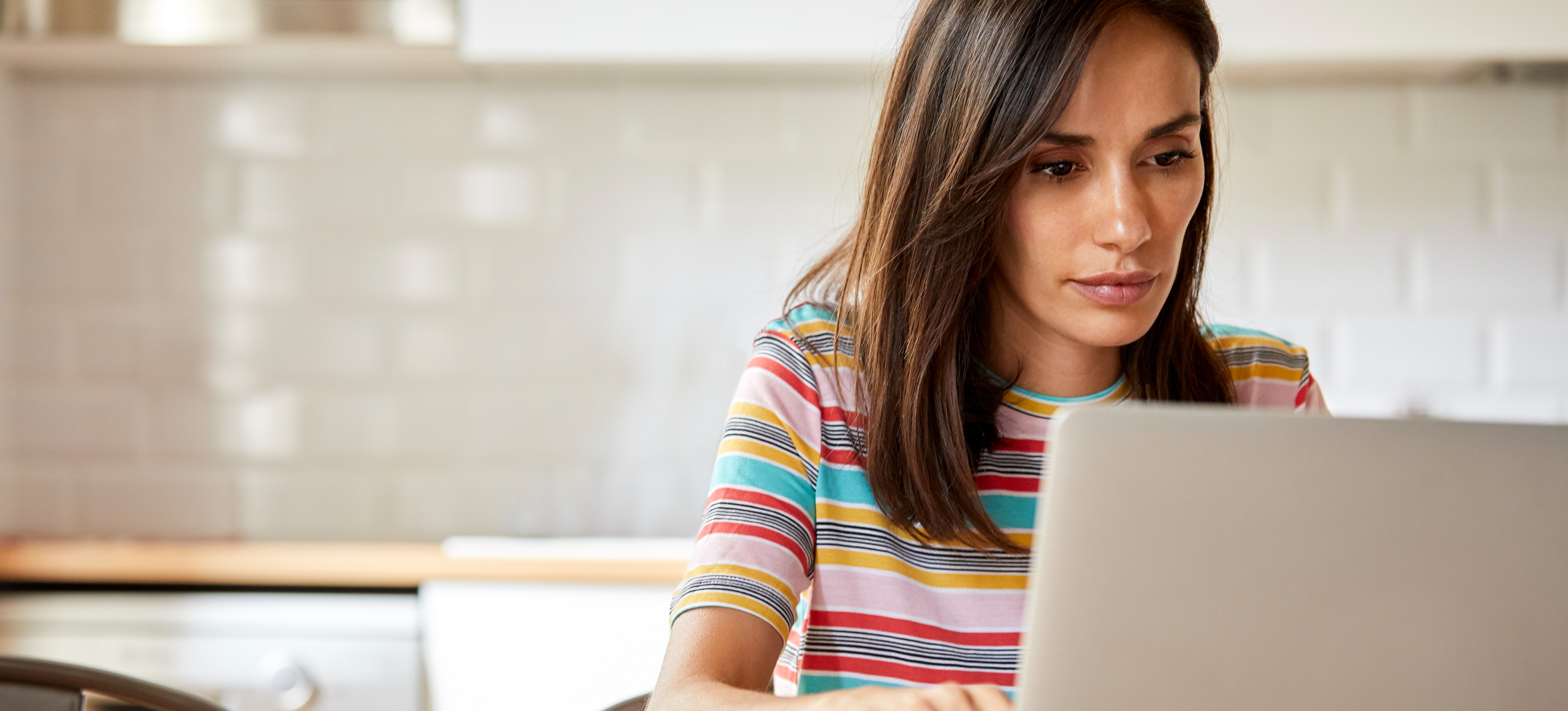 [Featured Image] A person who recently earned certifications works on creating a CompTIA A+ resume. 
