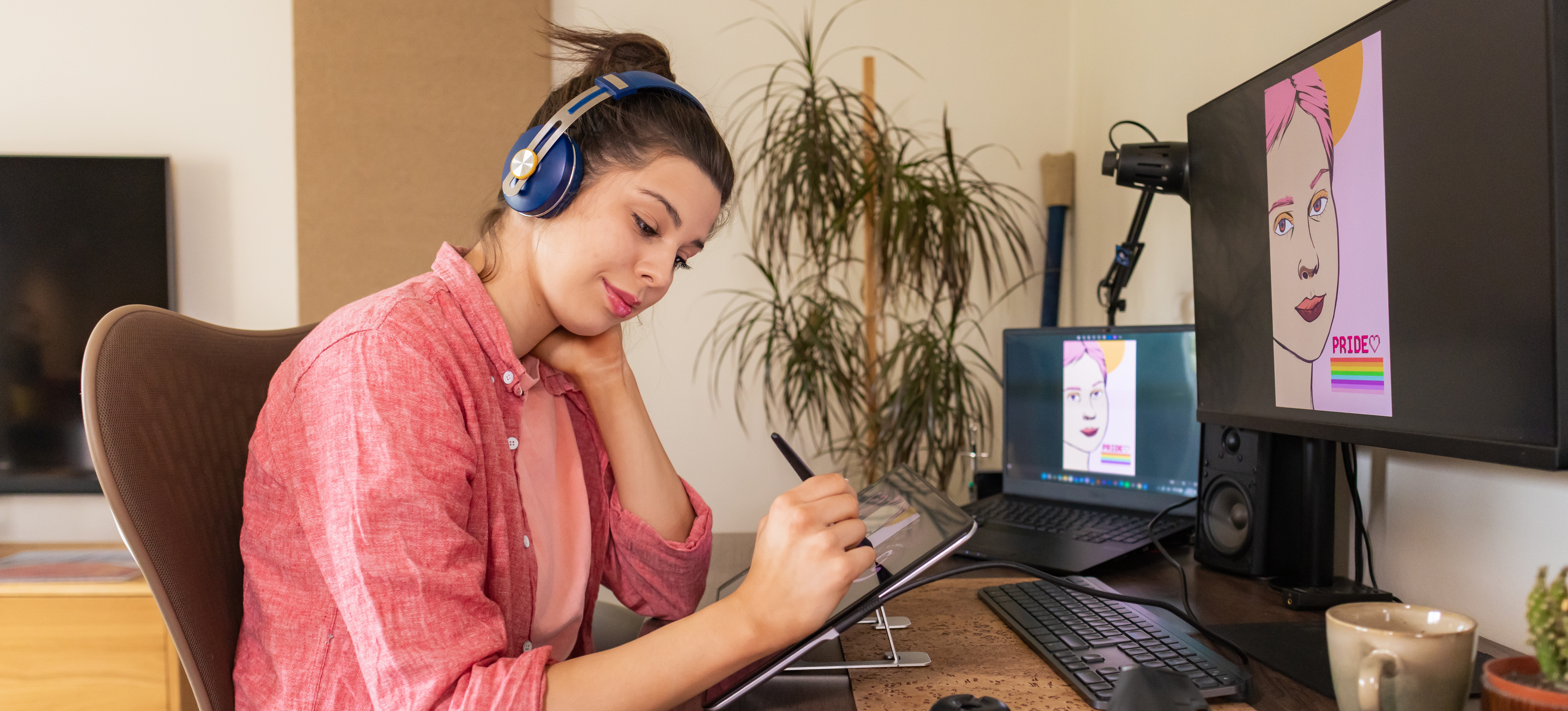 [Featured Image]: A person uses a tablet to create a digital design, one of the tasks you may see in a graphic design job description.
