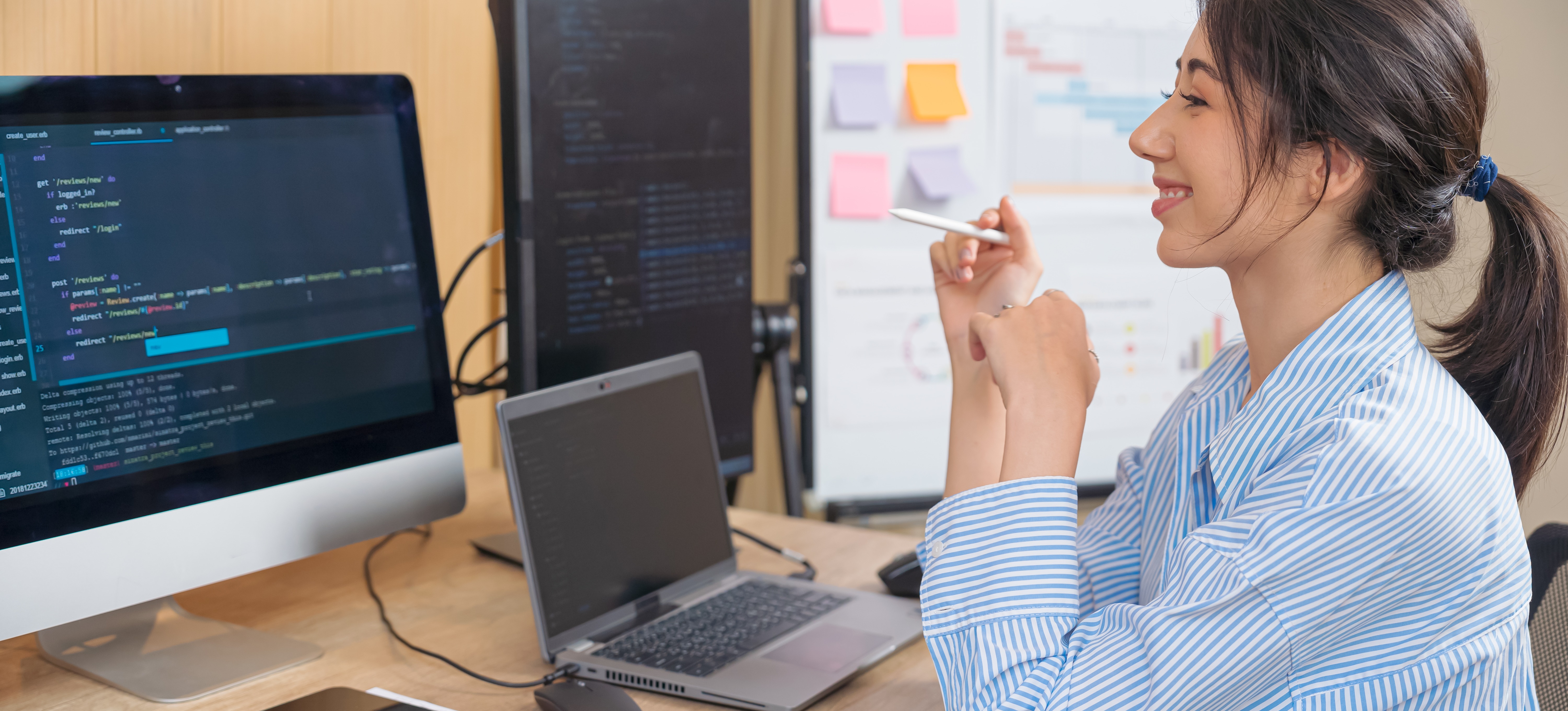 [Featured Image] A programmer smiles while working on a computer displaying lines of code, representing the comparison of Llama vs. Alpaca LLM programming models.
