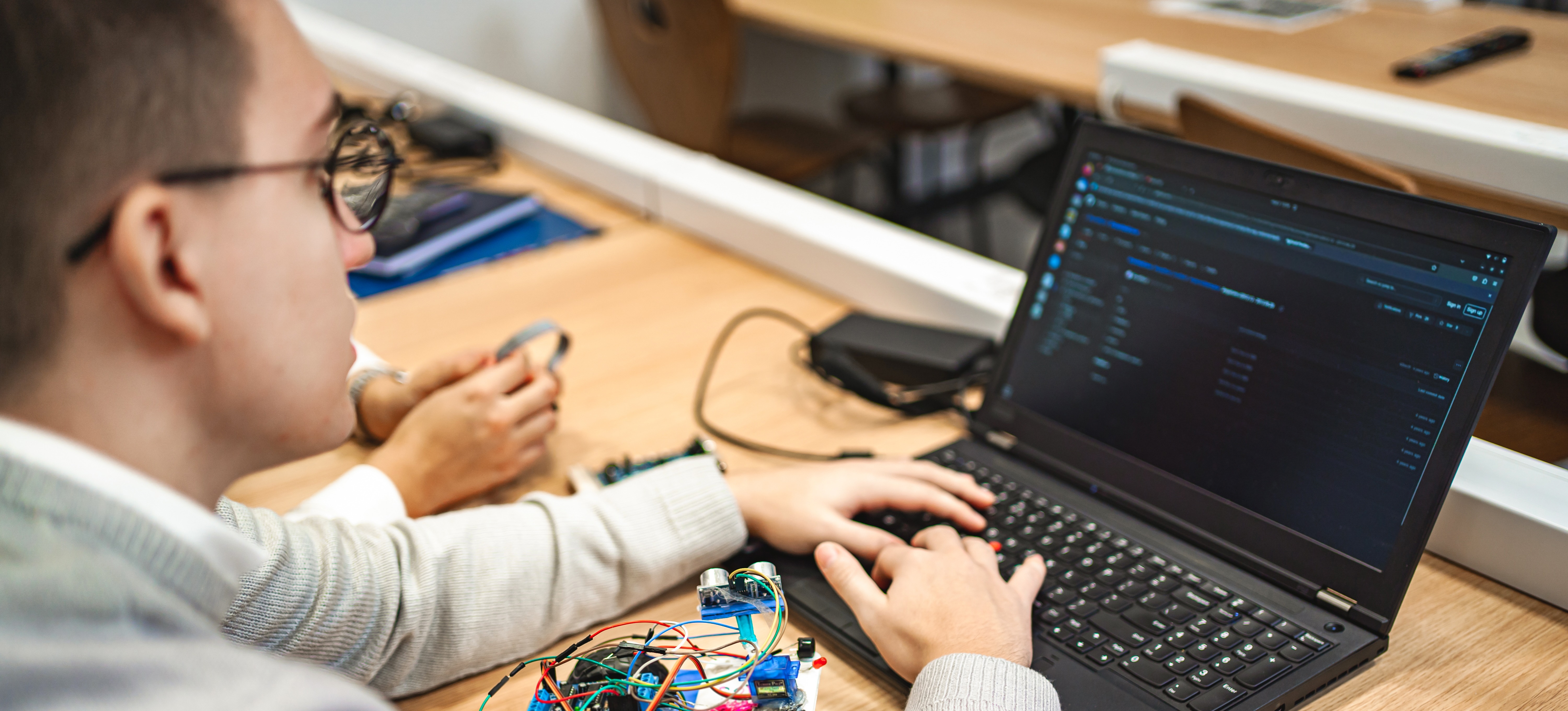 [Featured Image] A young student works on a project during an engineering course to help decide if an engineering degree is worth it.
