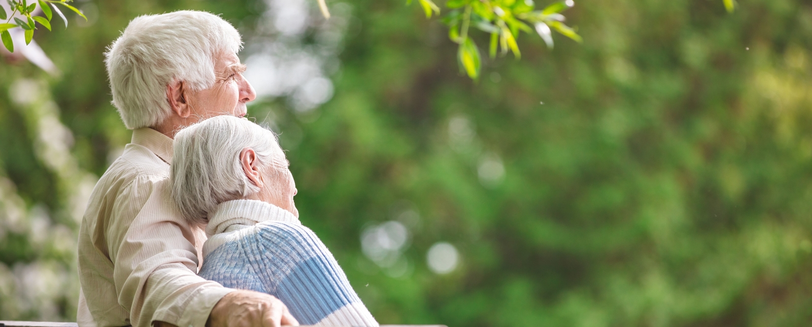 An elderly couple on a bench