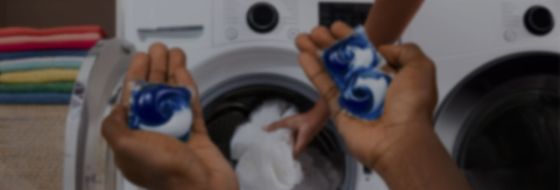 A person holding Tide PODS washing capsules