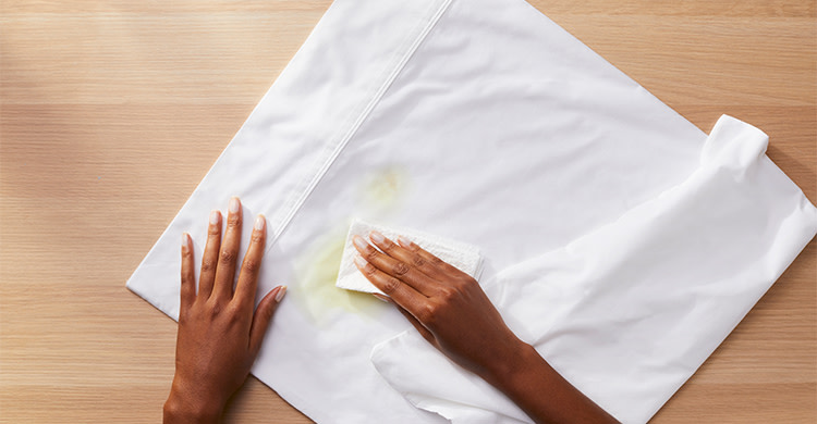 A person blotting excess with paper towel