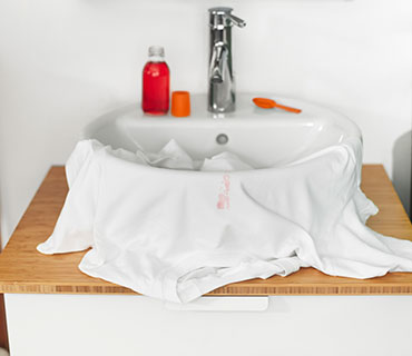 Stained, white garment in the sink 