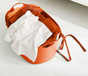 A clean white underwear on the top of a laundry basket