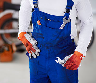 A person wearing oil-stained work clothes