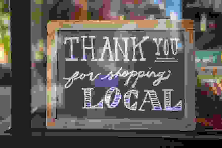 A photo of a sign that says thank you for shopping local