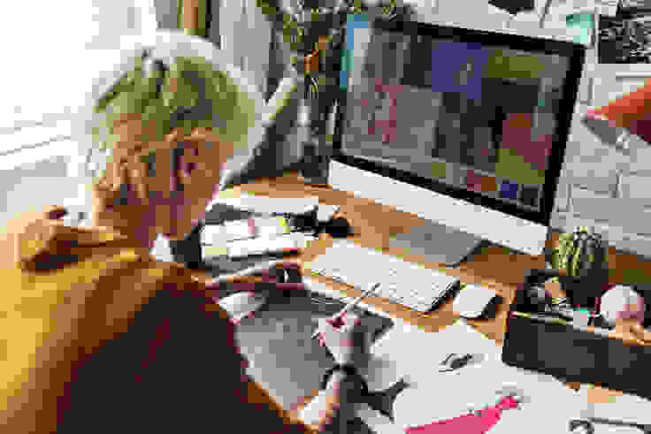 Artist drawing and working on a computer