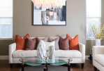 a living room with a white couch and a table with a glass coffee table